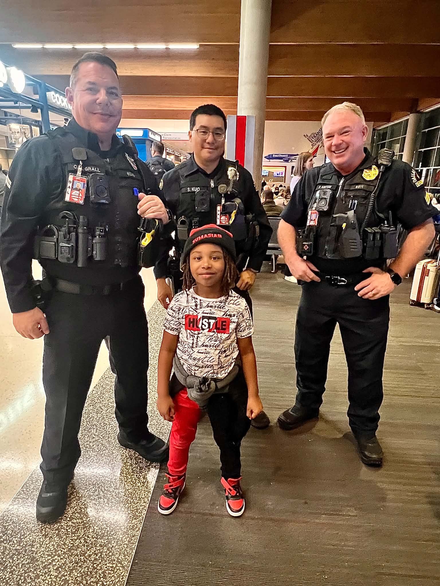 Child meeting community officers at the airport