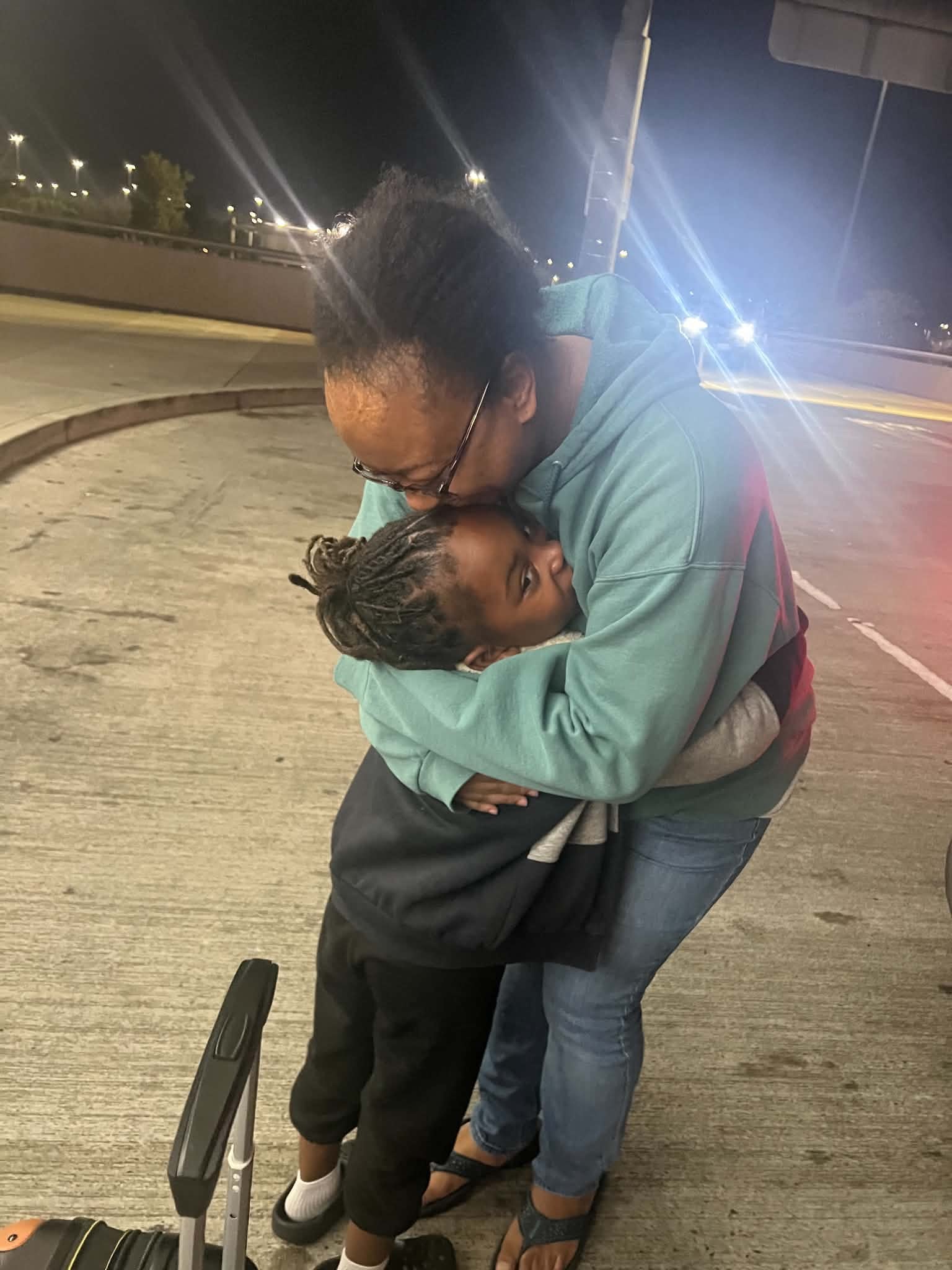 Adult embracing a child during a family travel moment