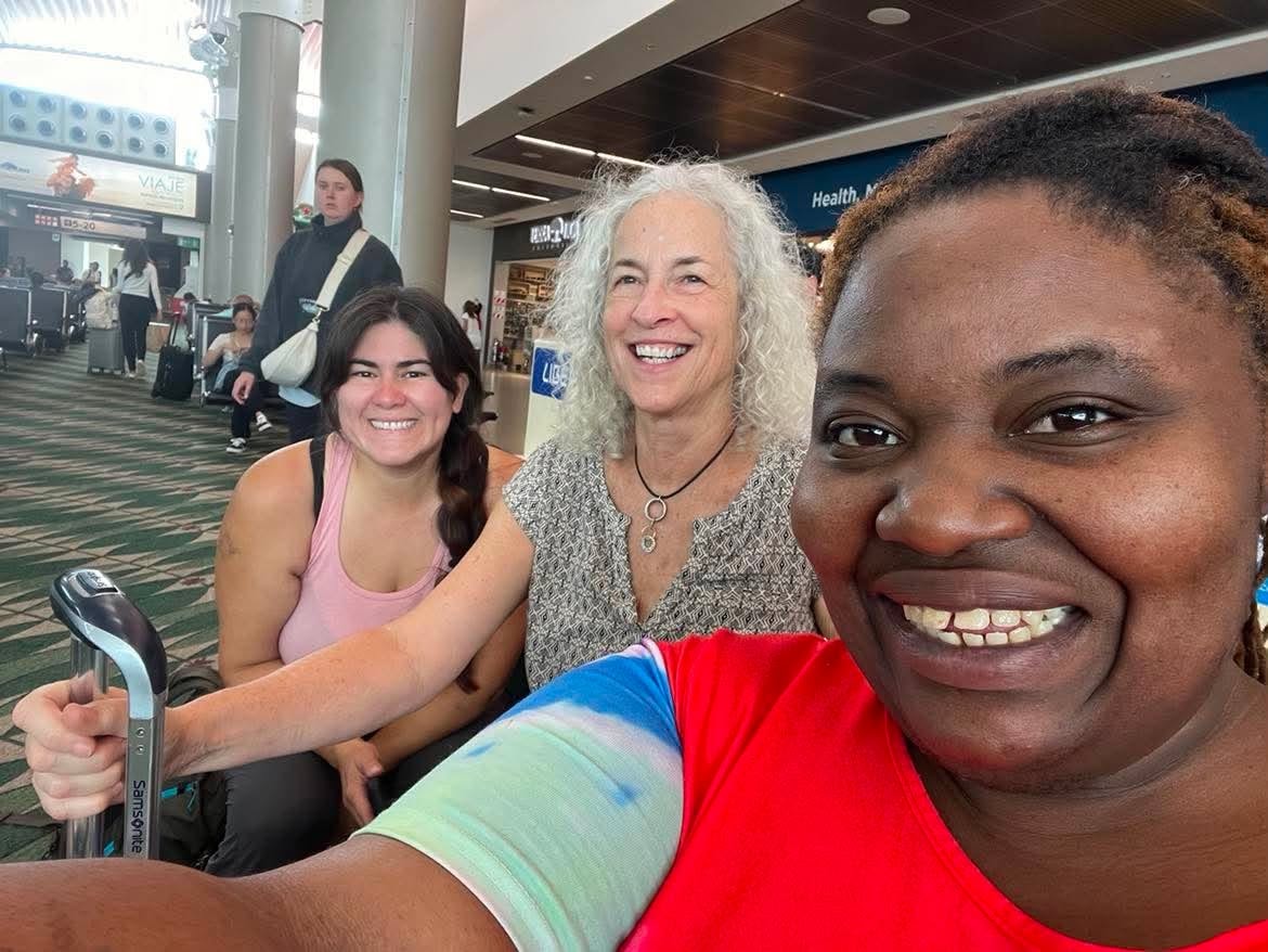 Community members sharing a travel moment at the airport
