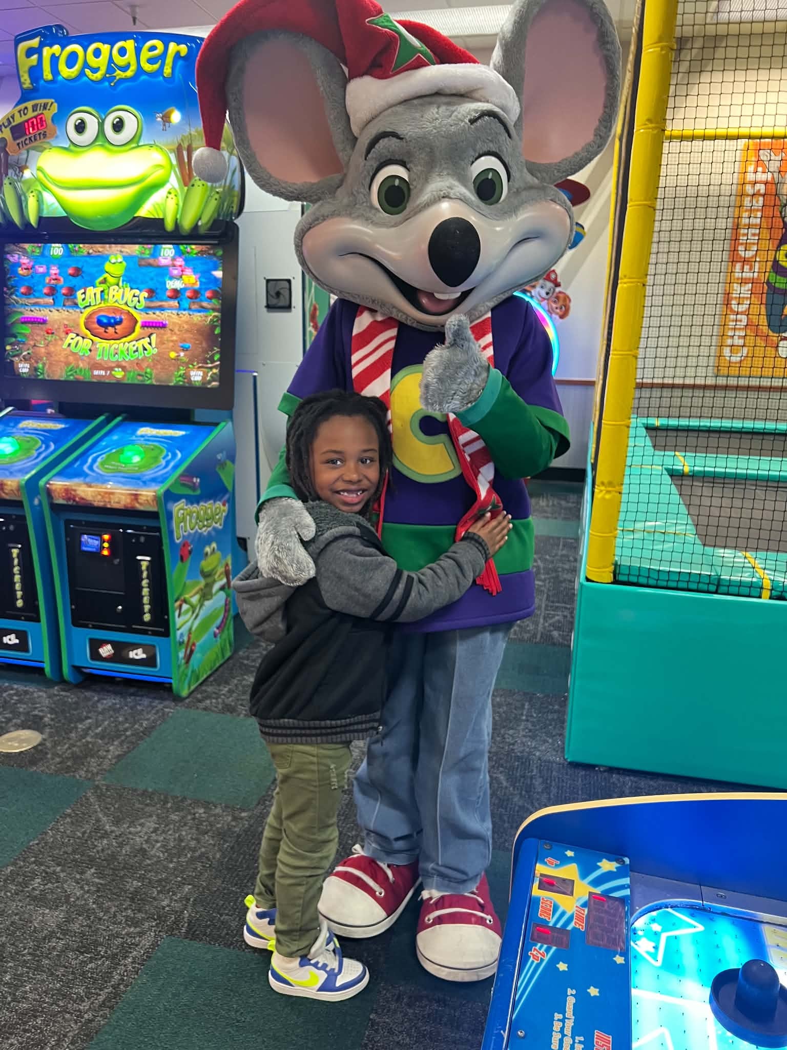 Child hugging a character during a family entertainment outing