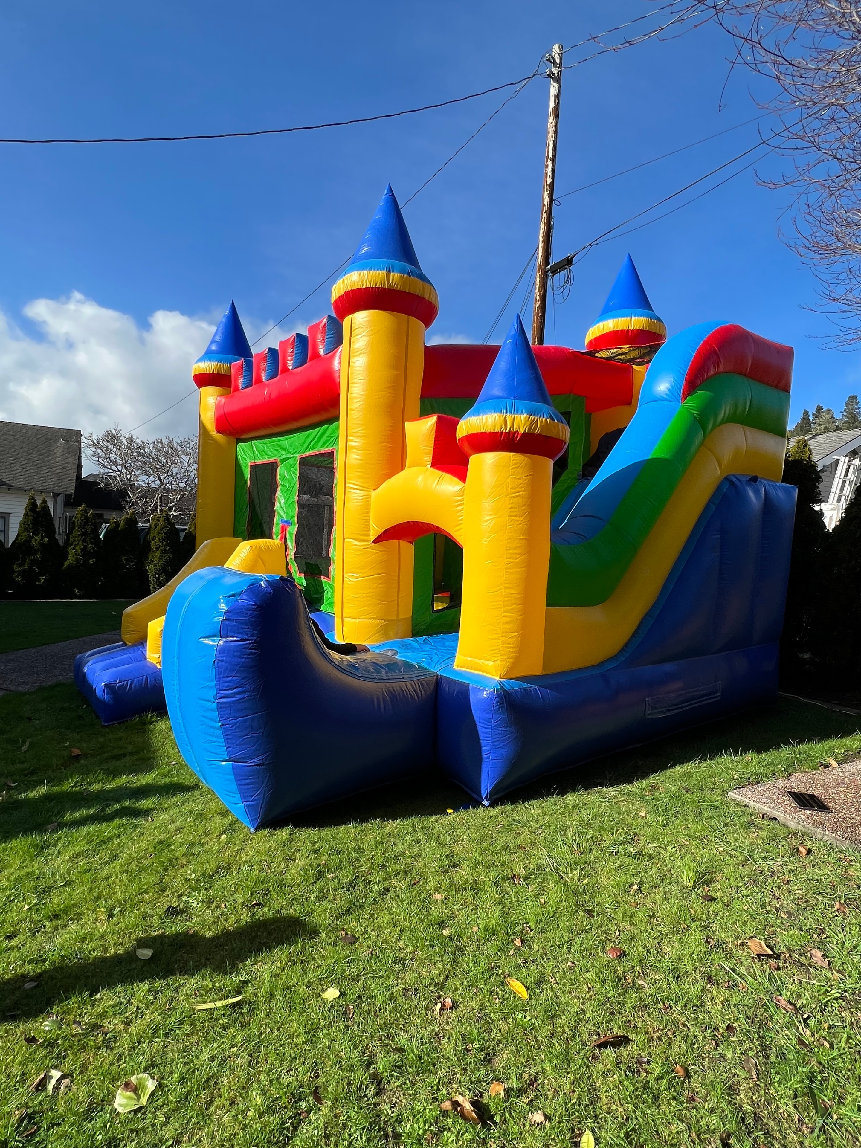 Colorful inflatable castle bounce house on a lawn