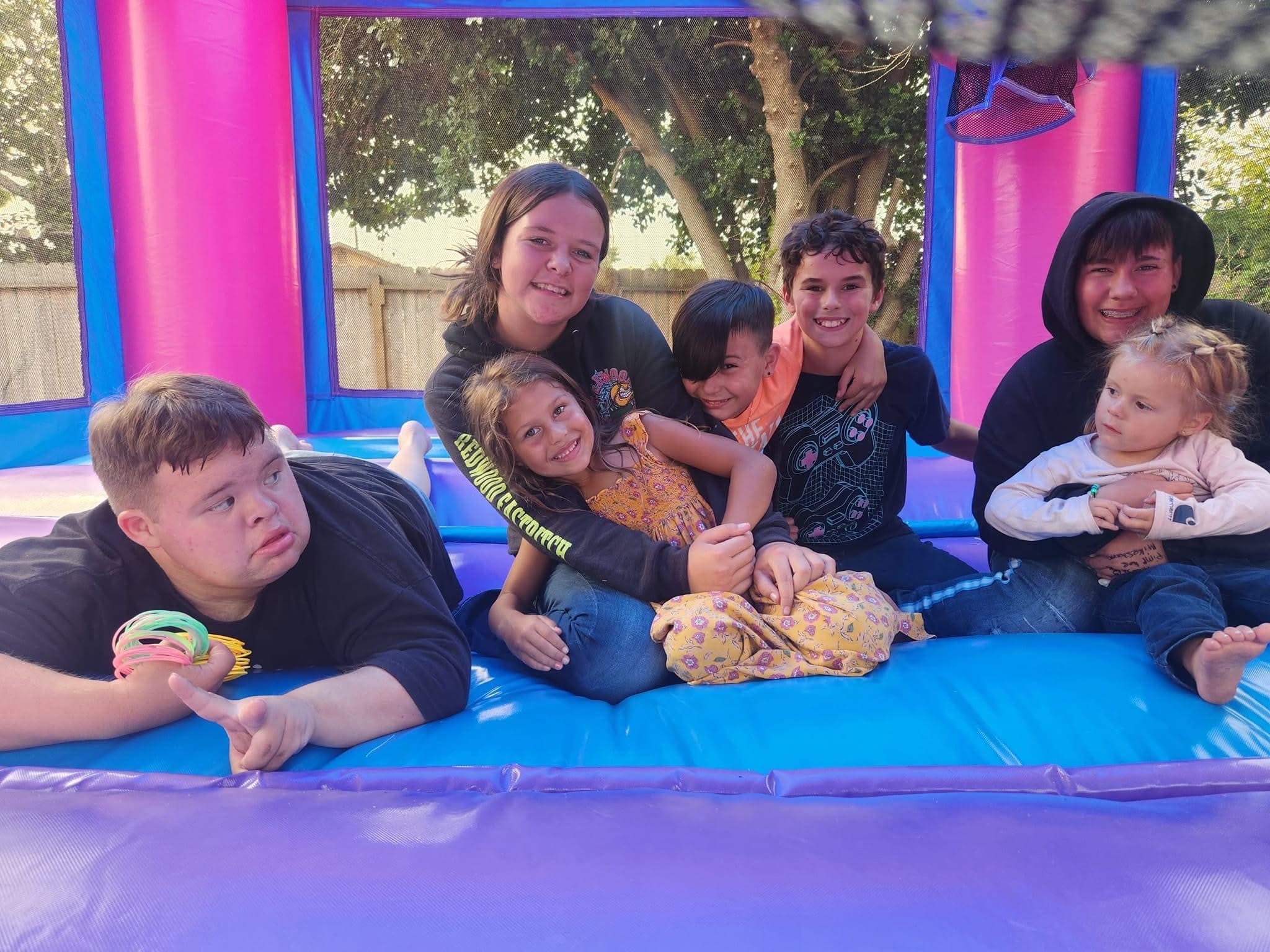 Children and friends enjoying a colorful bounce house together
