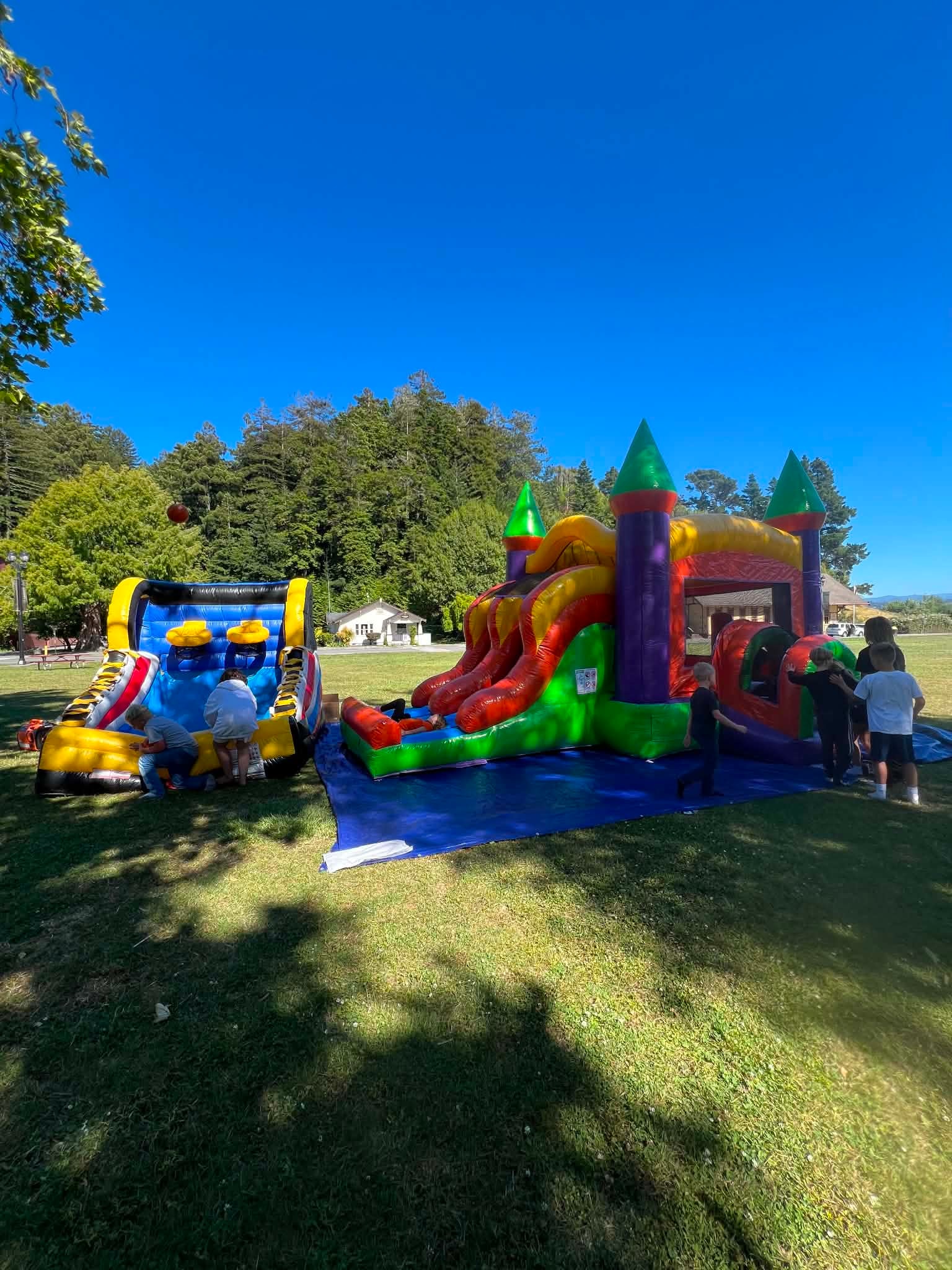 Children enjoying colorful bounce houses at an outdoor event