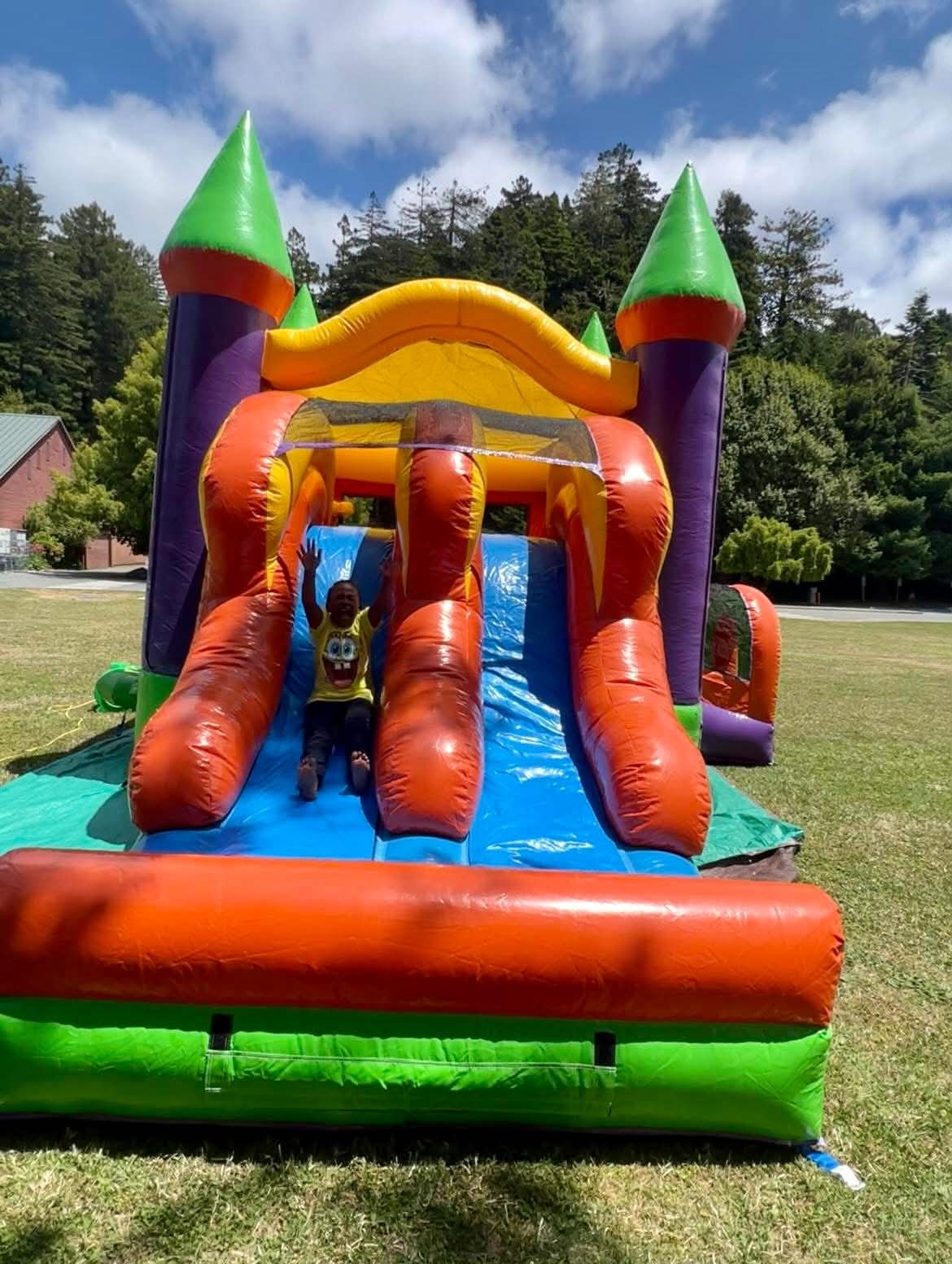 Child enjoying a colorful inflatable bounce house