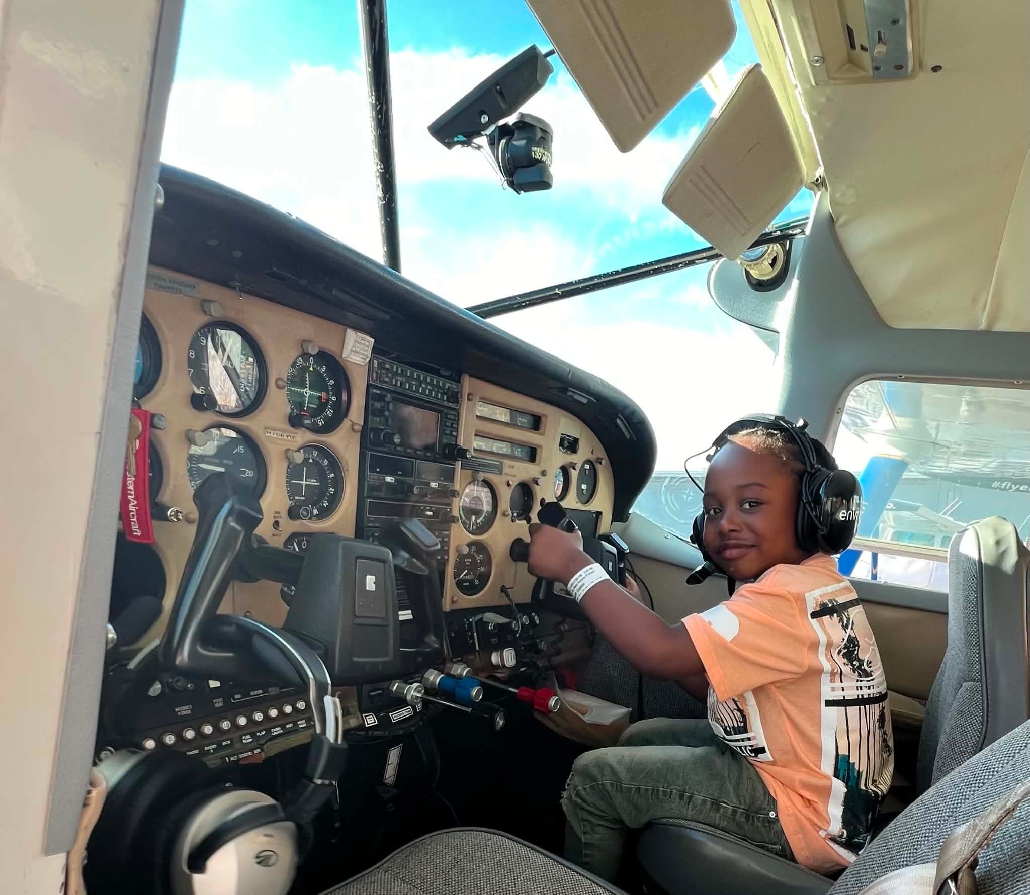 Child enjoying an aircraft cockpit experience