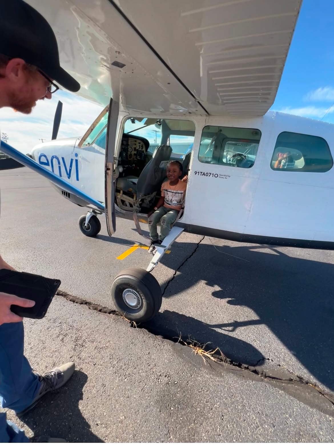 Child enjoying a small airplane adventure on the tarmac