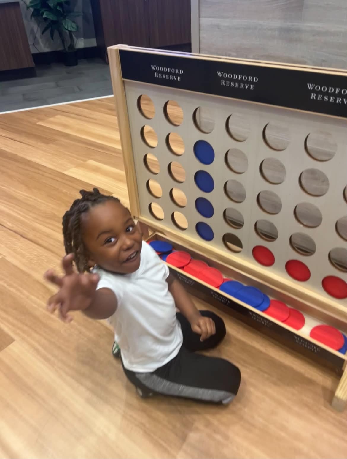 Child enjoying a Connect Four game activity