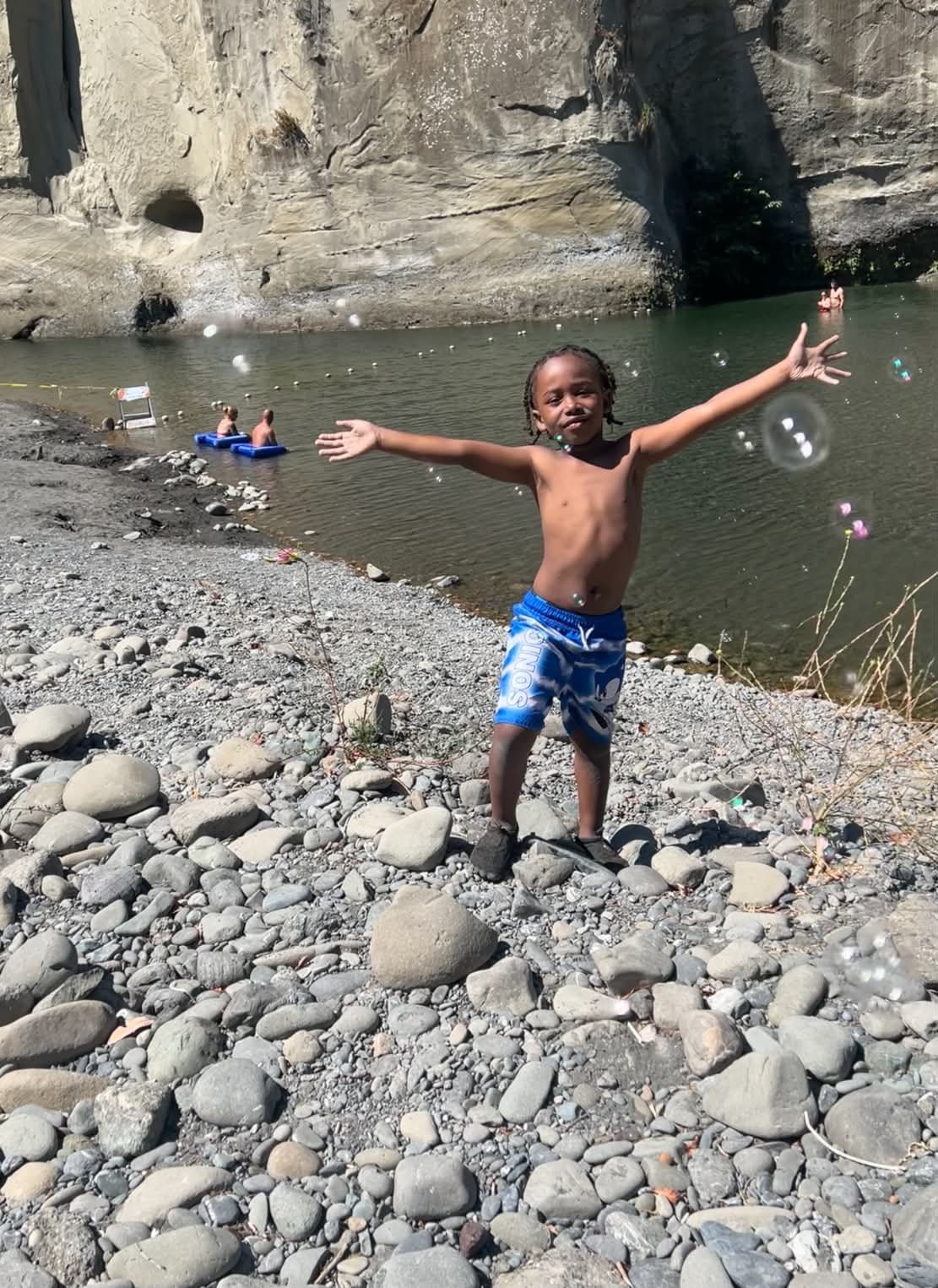 Child enjoying a sunny river swimming adventure