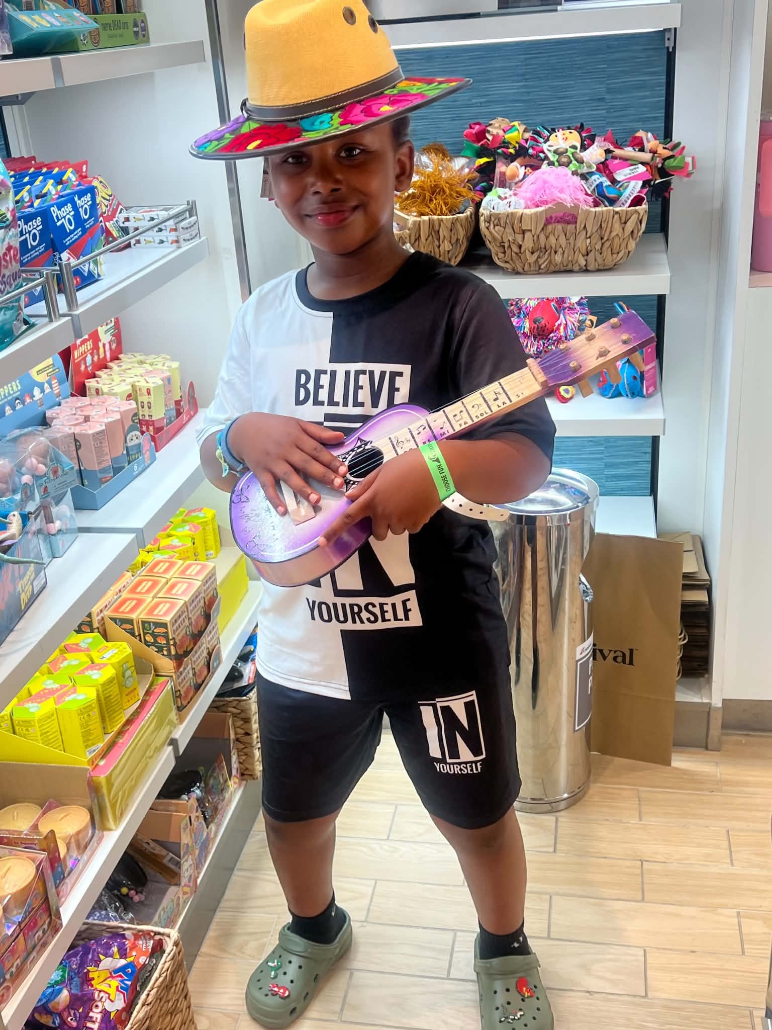 Child holding a colorful toy guitar at a community gathering