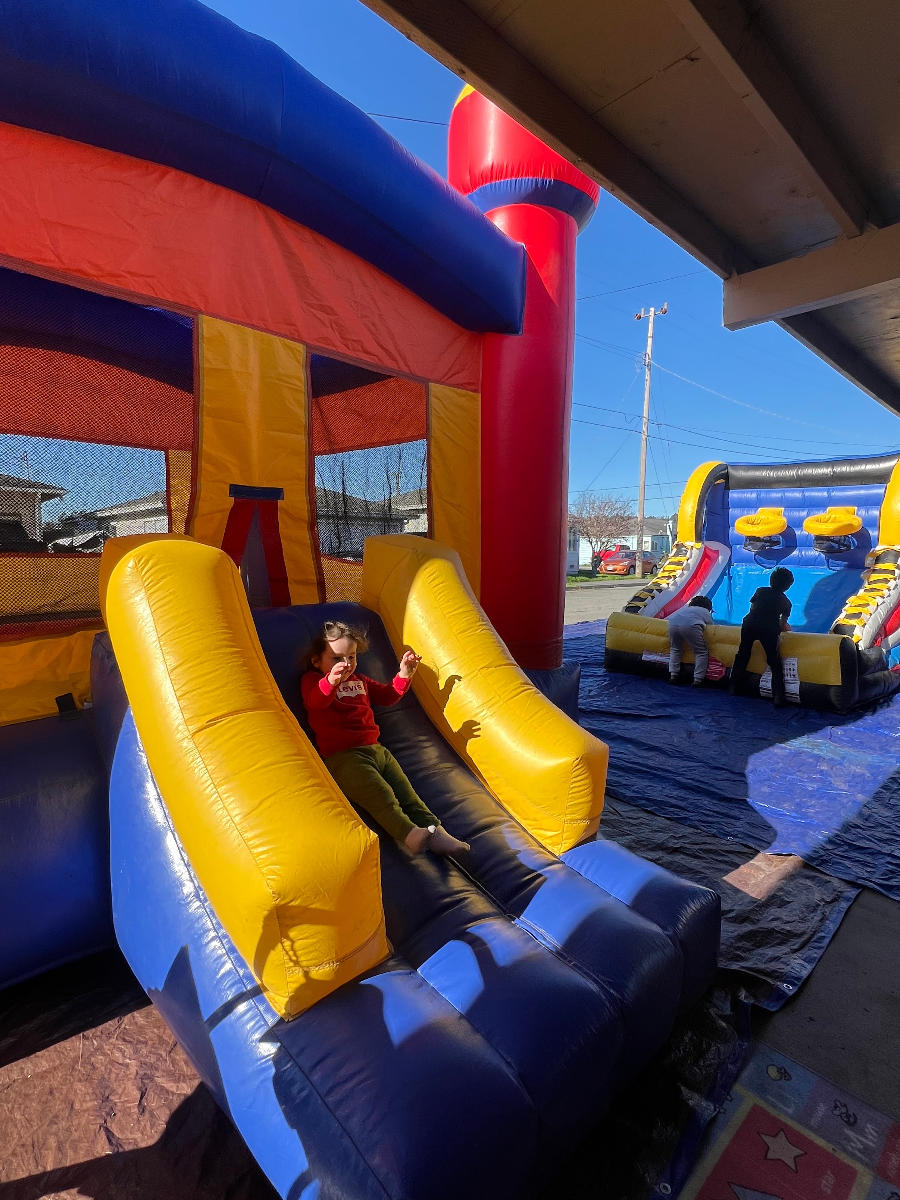Children playing inside a colorful bounce house