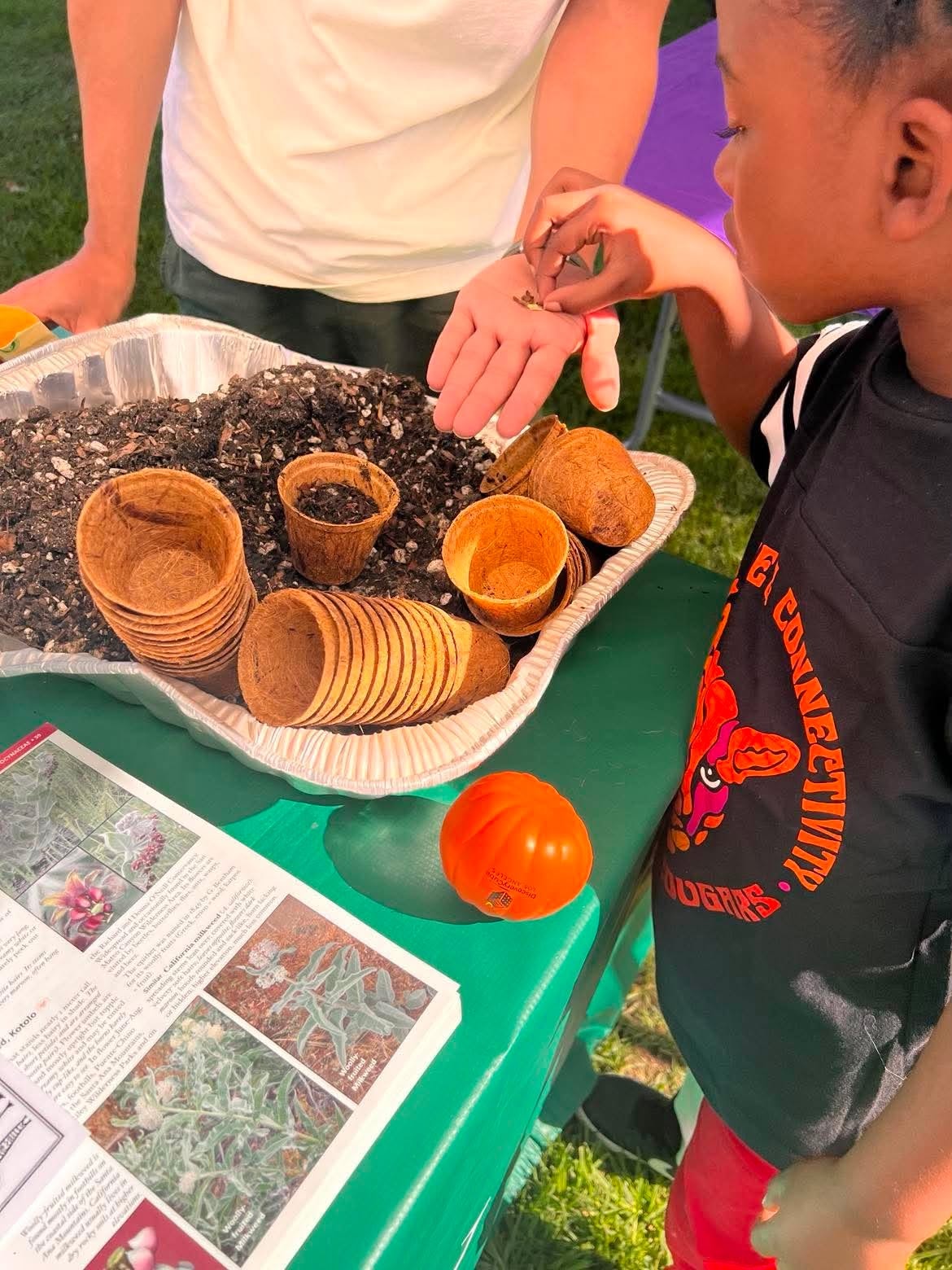 Child exploring seeds and soil during a gardening activity