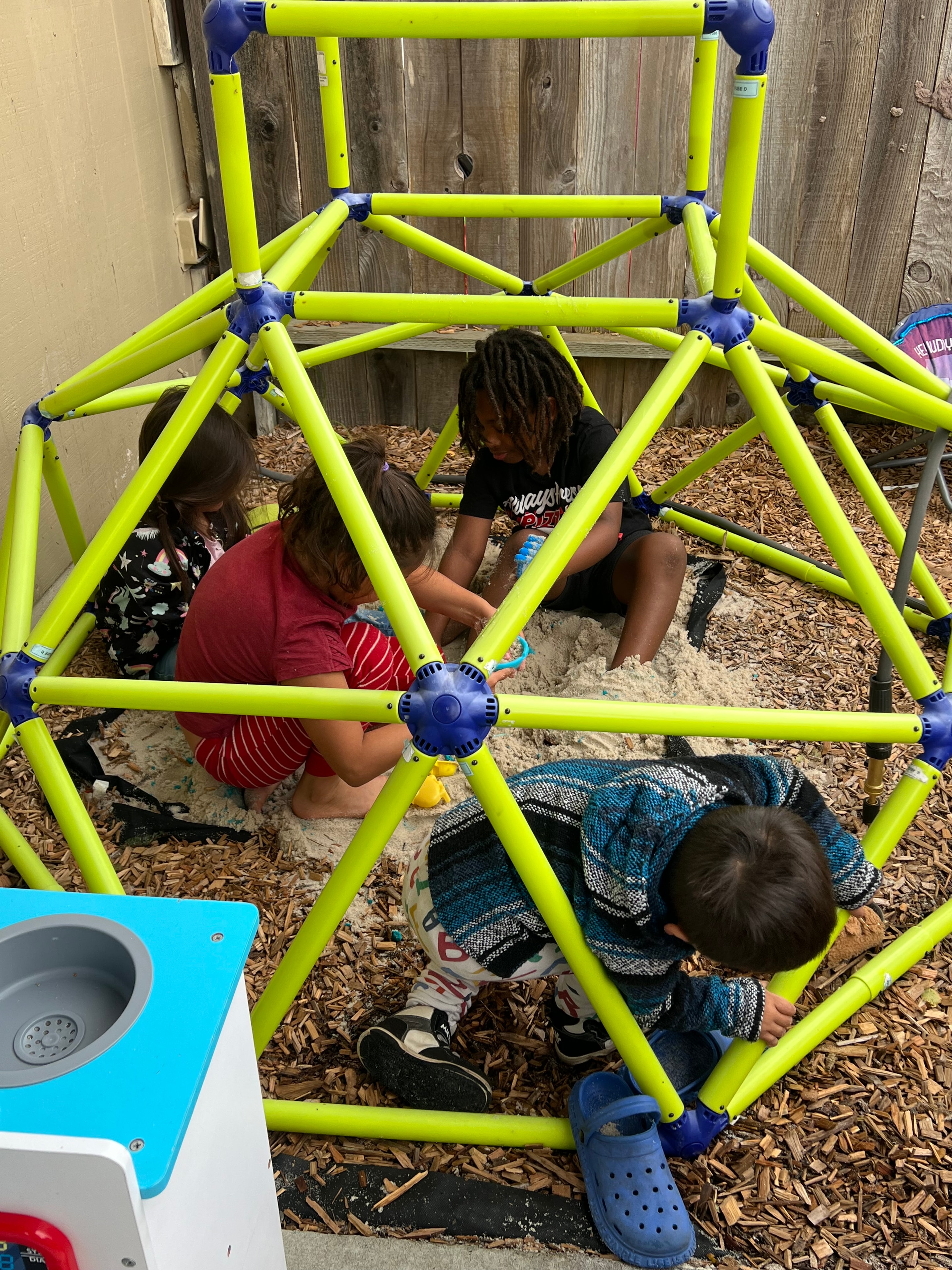 Children exploring and playing together in a sandbox