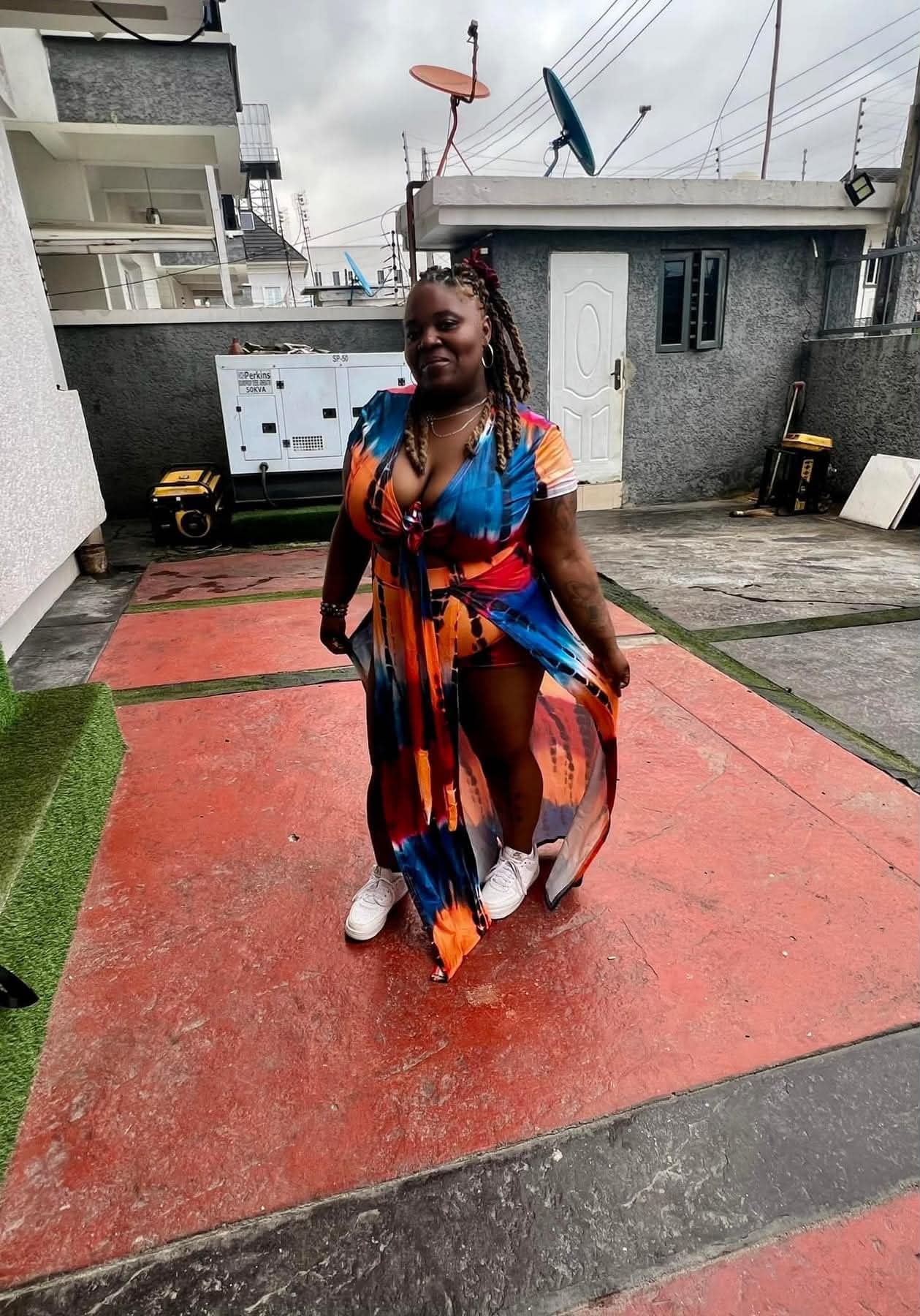 Community member in a colorful outfit during a travel experience