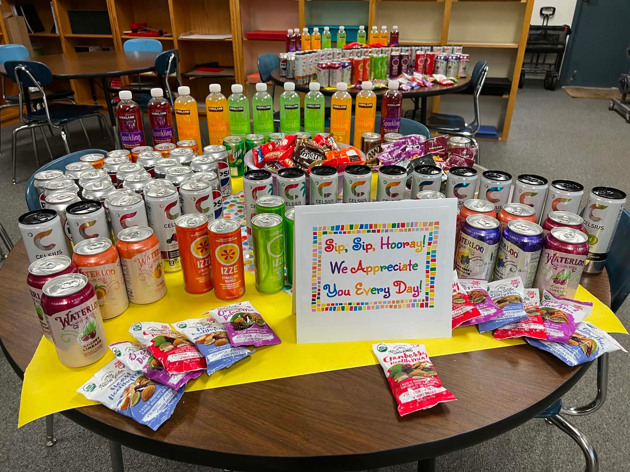Community appreciation table filled with drinks and snacks