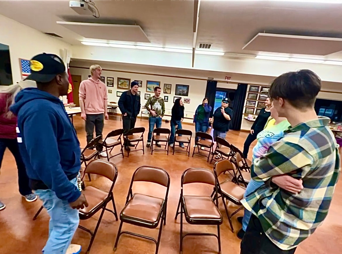 Neighbors joining a circle activity indoors