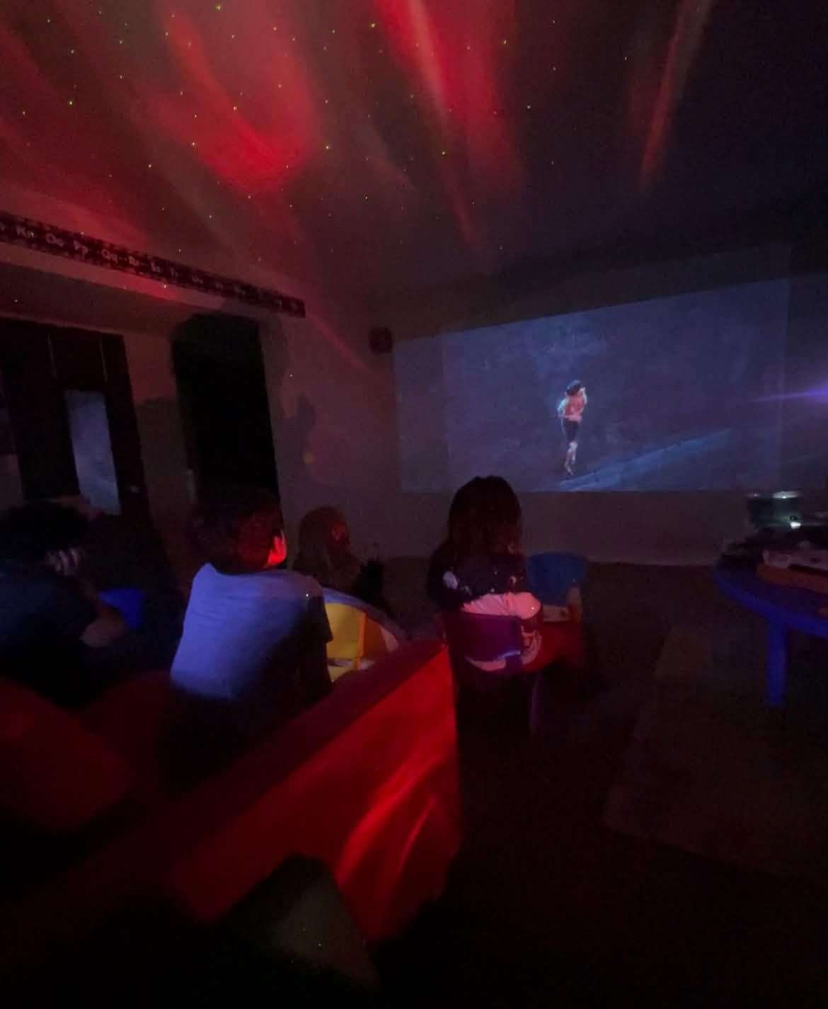 Community members enjoying a projected movie together