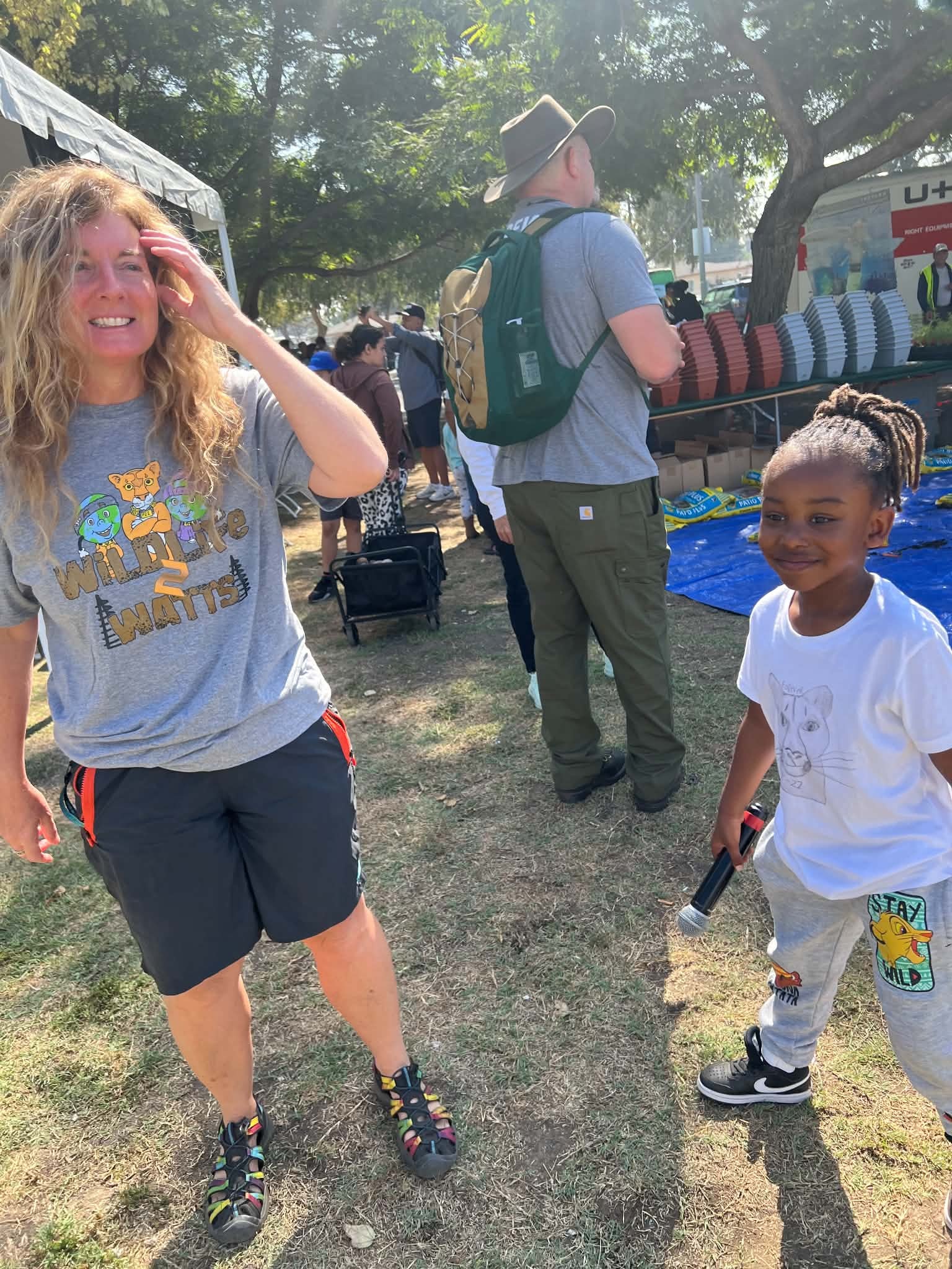 Child and community member at an outdoor service event