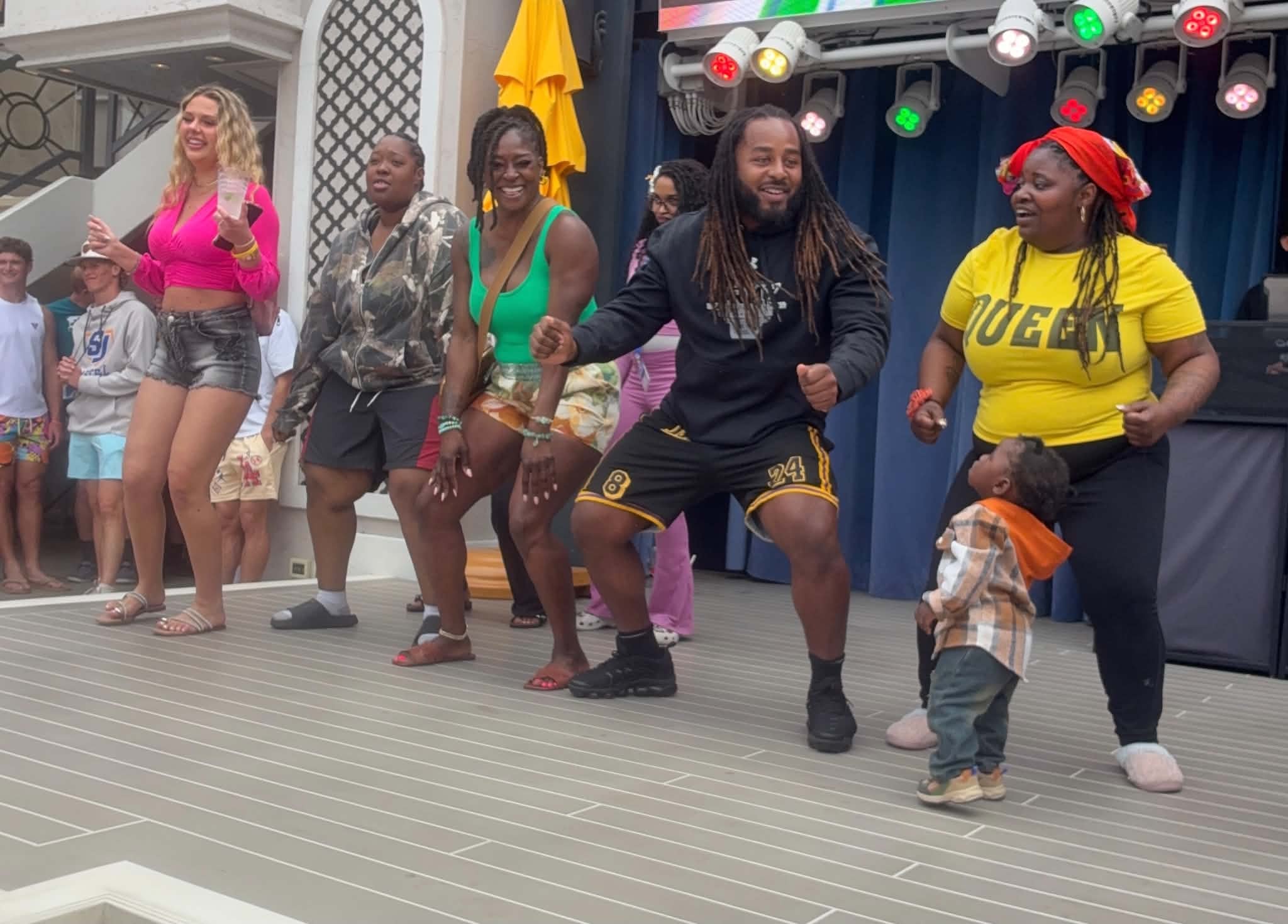 Community members dancing together on stage