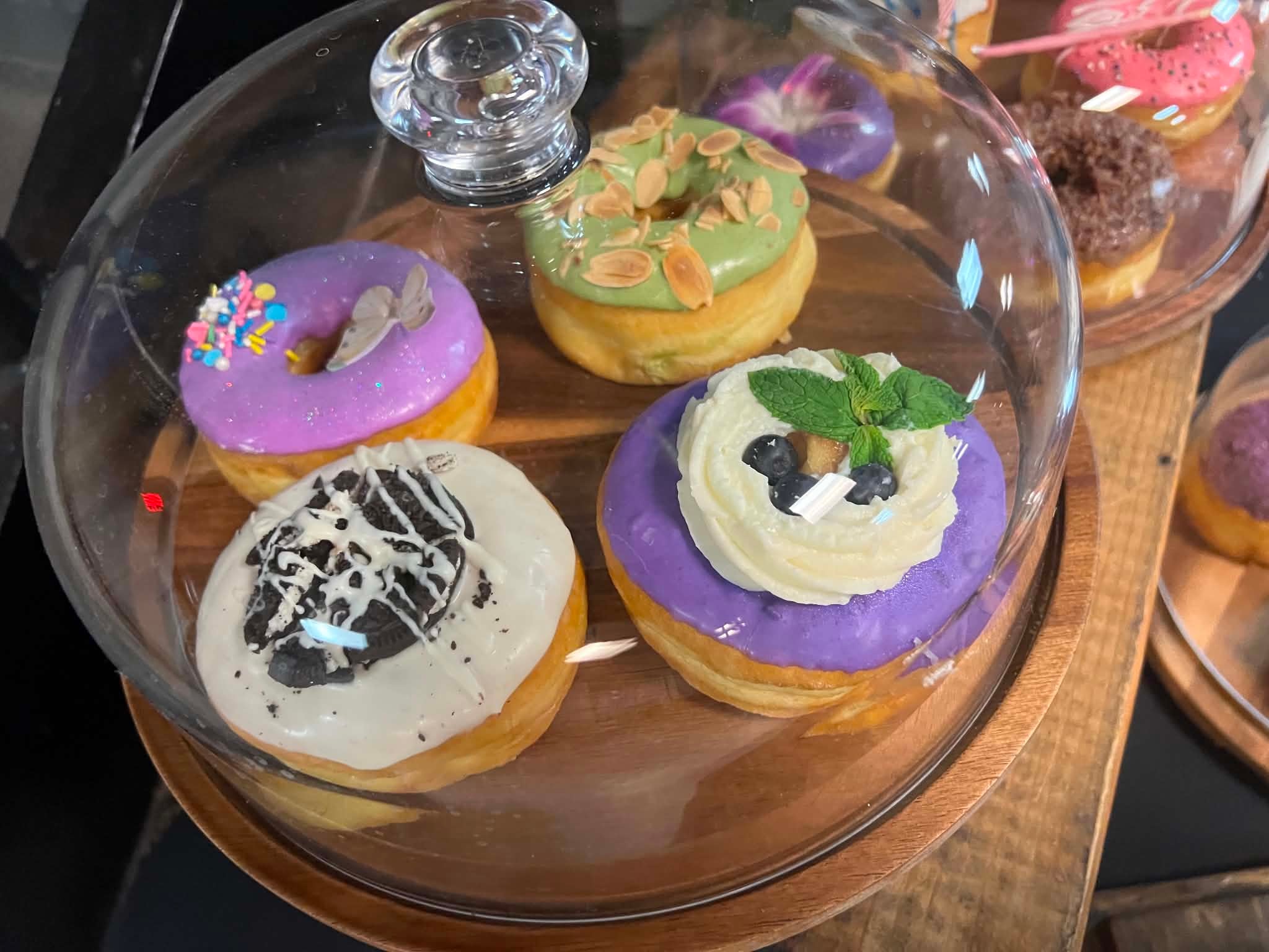 Colorful decorated donuts in a display dome
