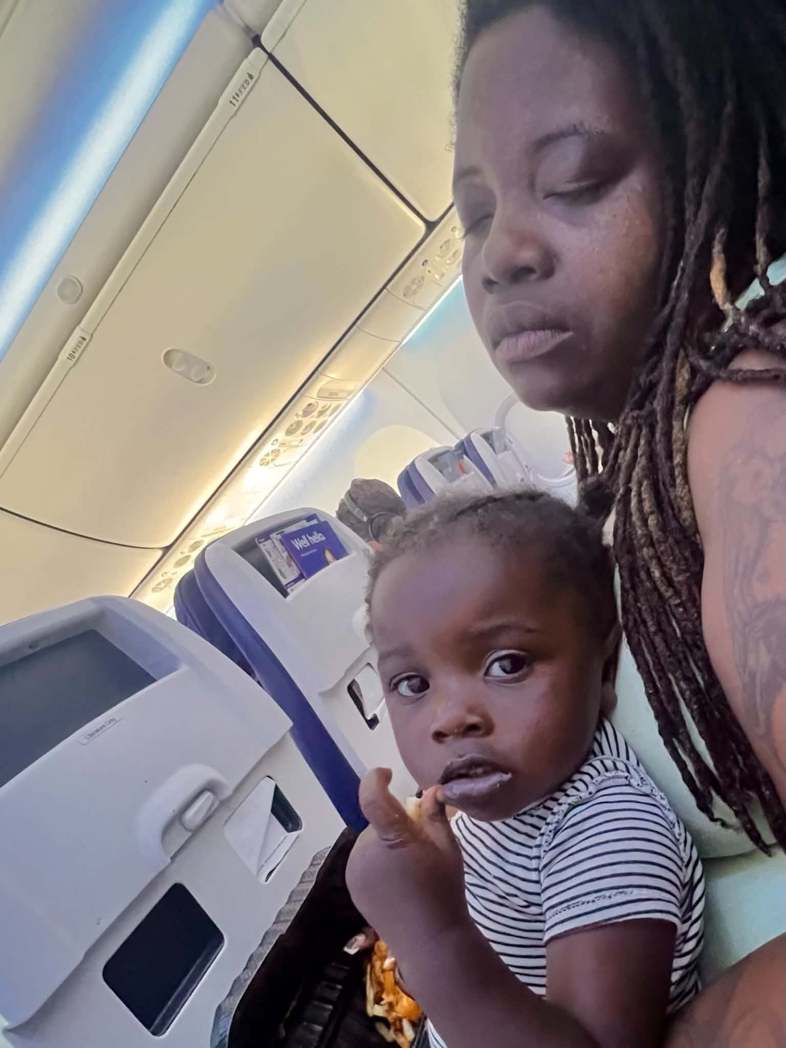 Adult and child traveling together on an airplane