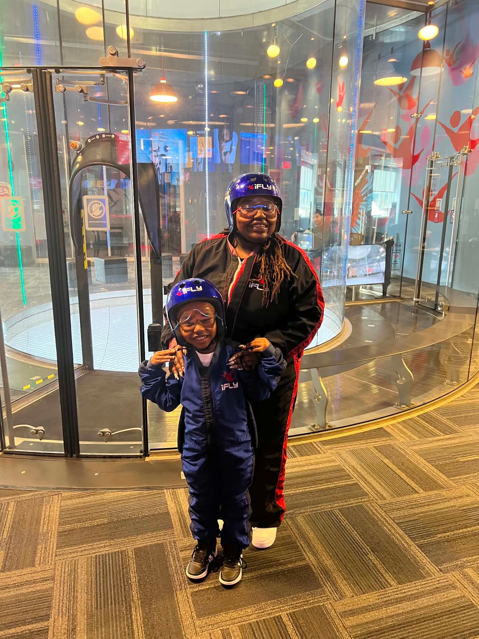 Adult and child ready for an indoor skydiving adventure