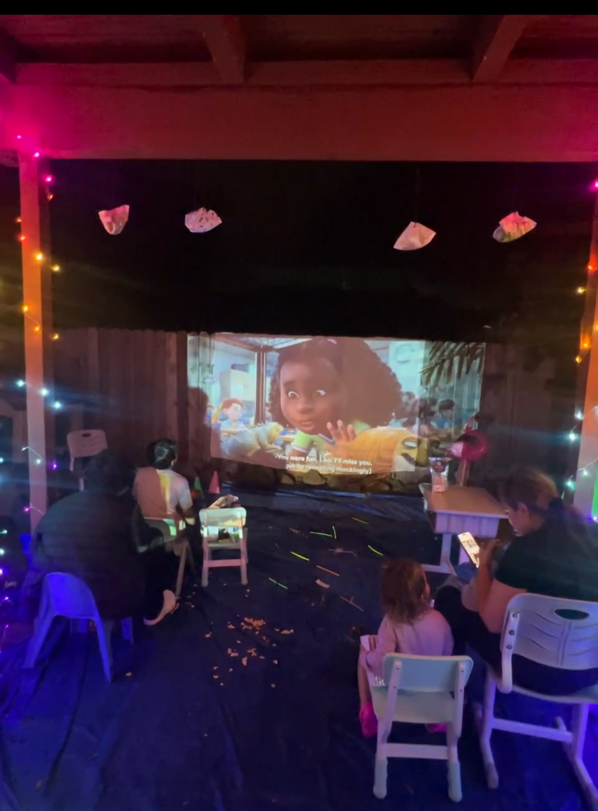 Children and families watching an outdoor movie night