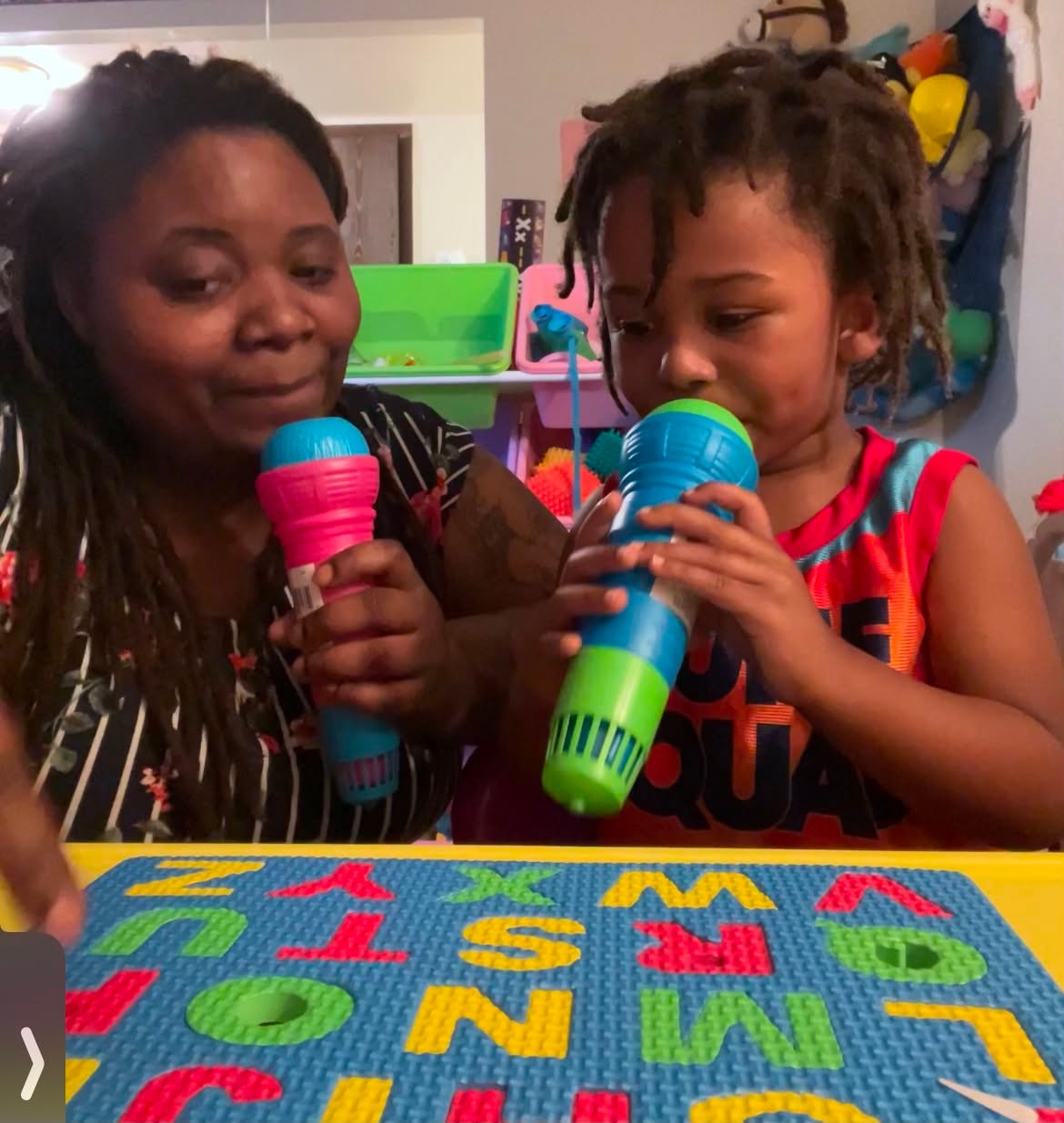 Adult and child sharing a playful music activity