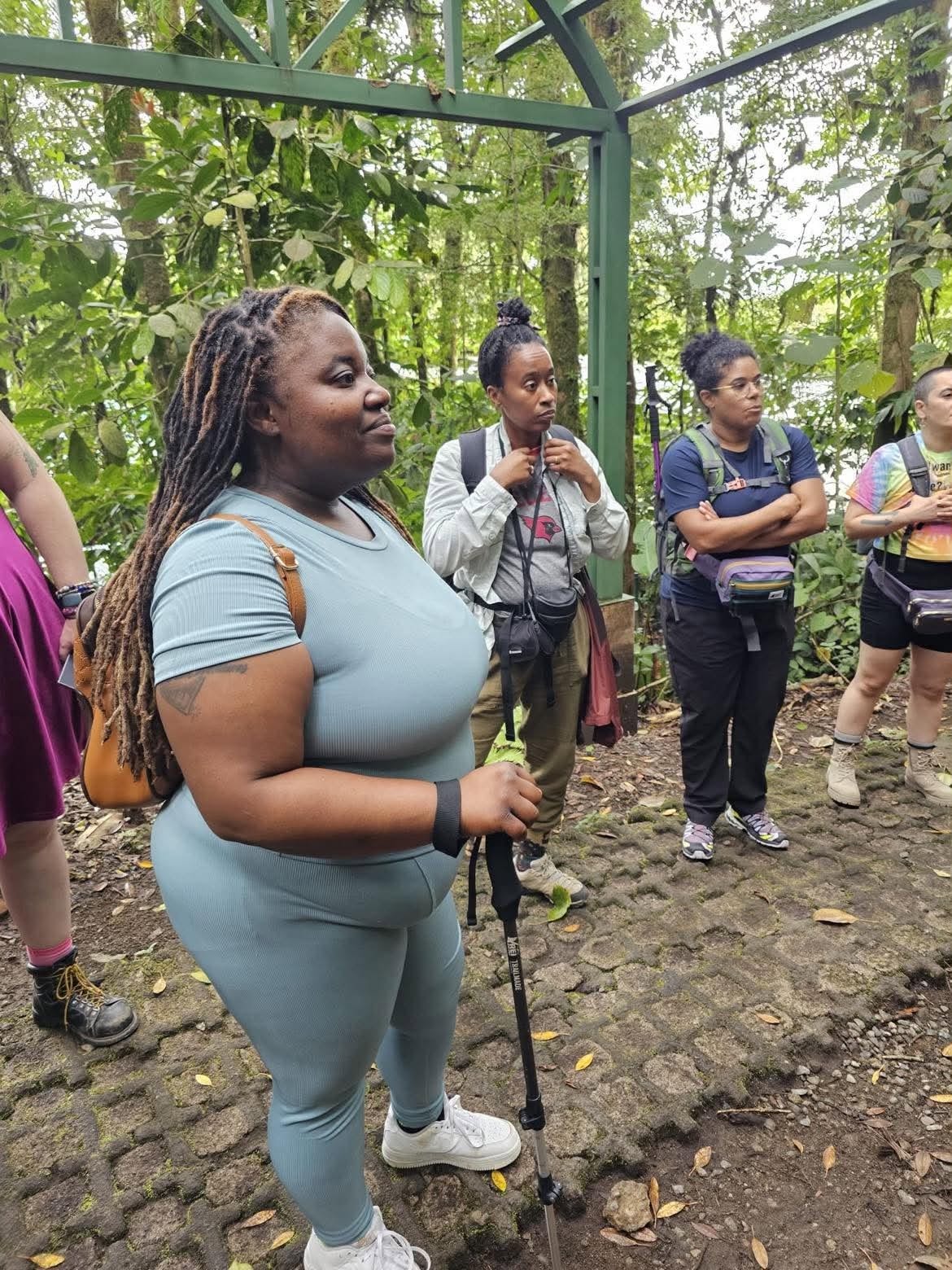 Community hiking group gathered in a lush forest