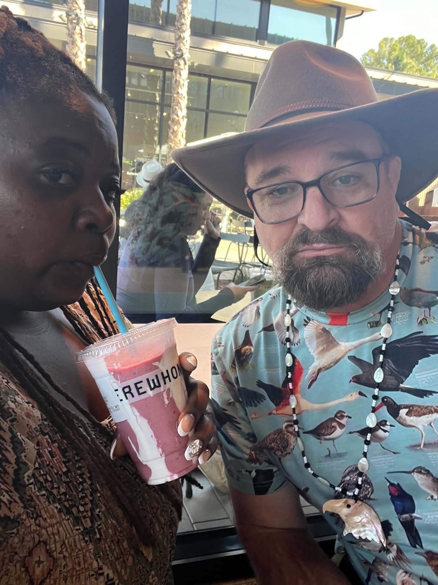 Two people enjoying a drink together outdoors
