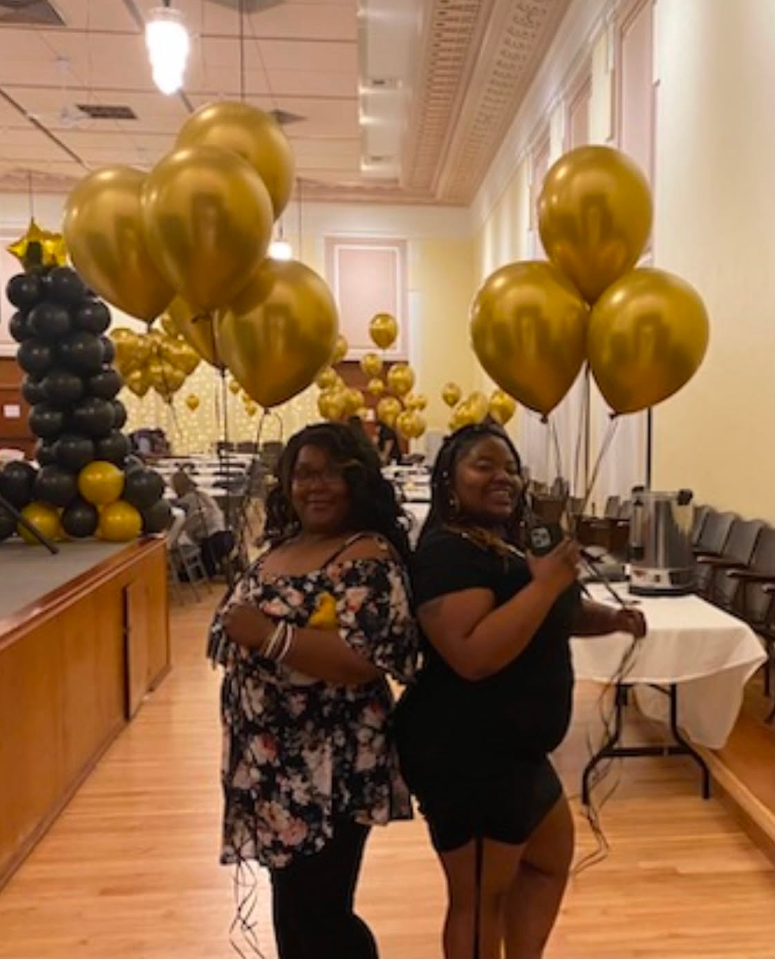 Community members celebrating at a gold balloon event