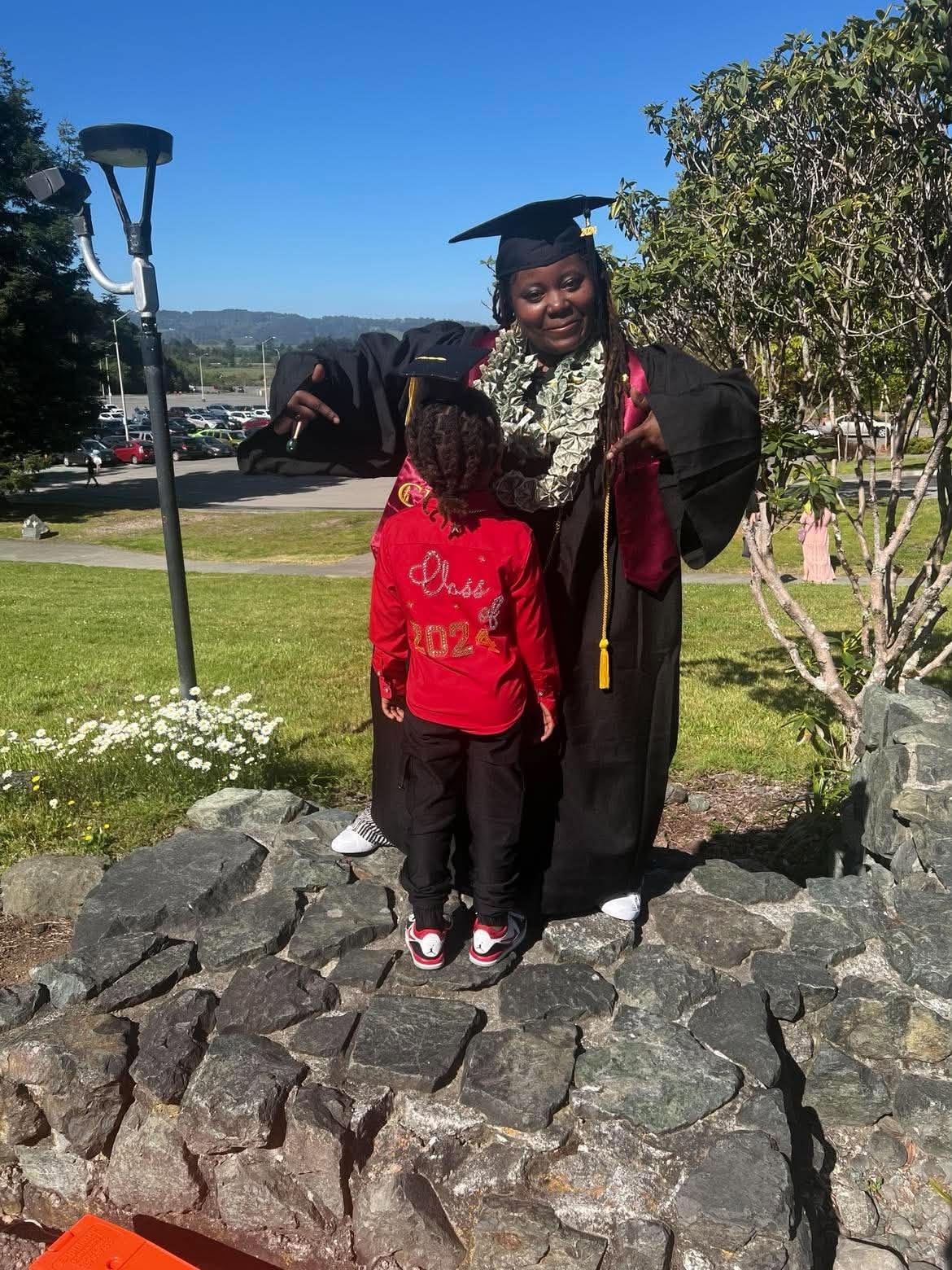 Graduate celebrating a meaningful family milestone outdoors