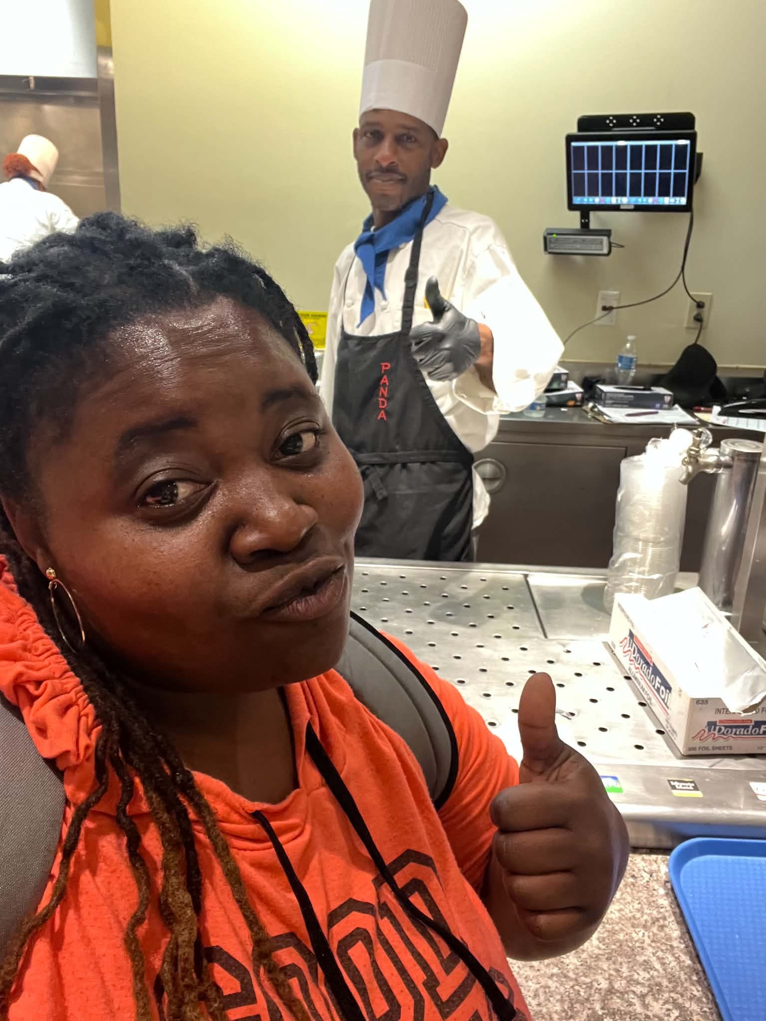 Community member visiting with a chef in a kitchen
