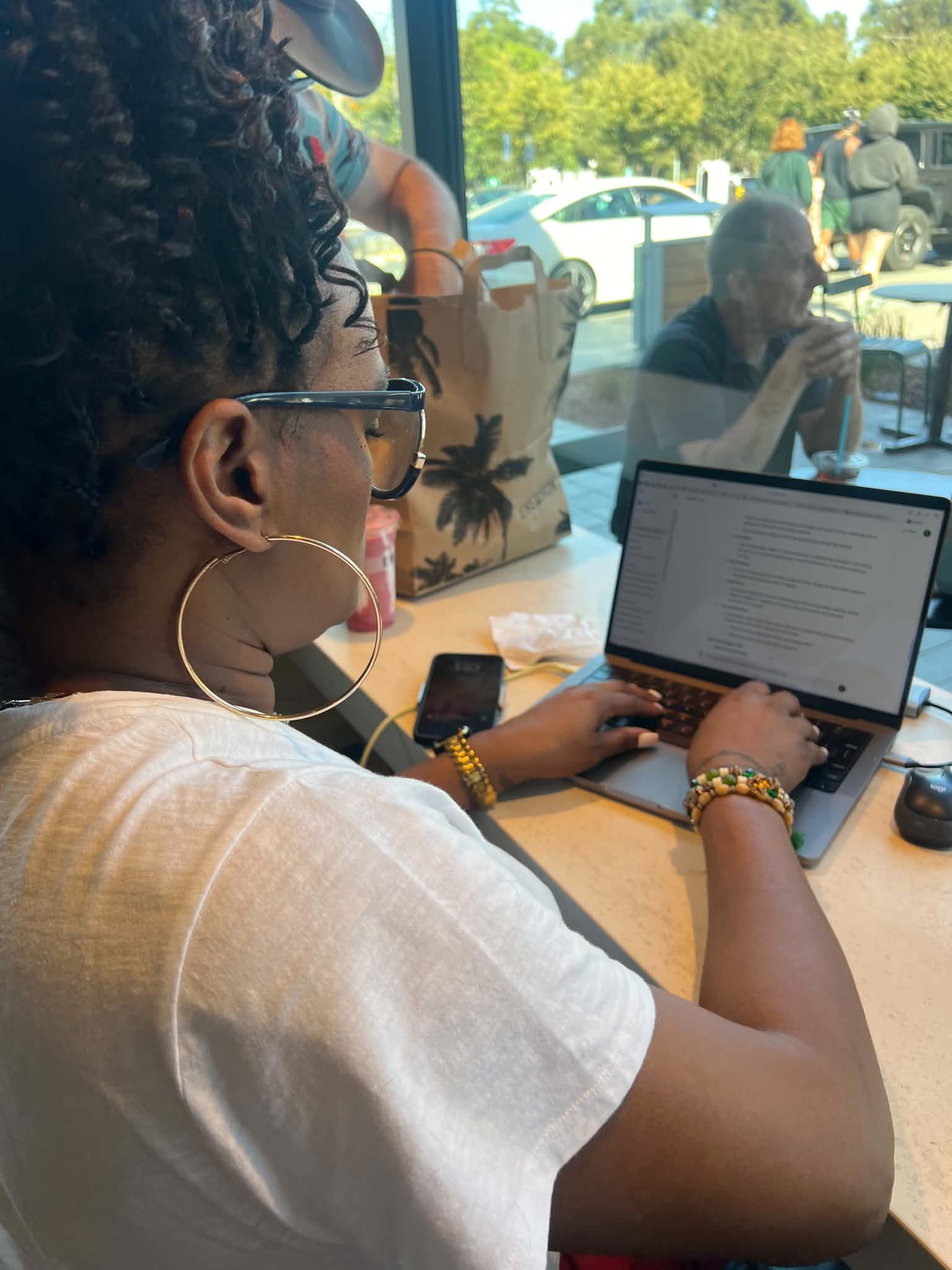 Community member working on a laptop in a collaborative setting