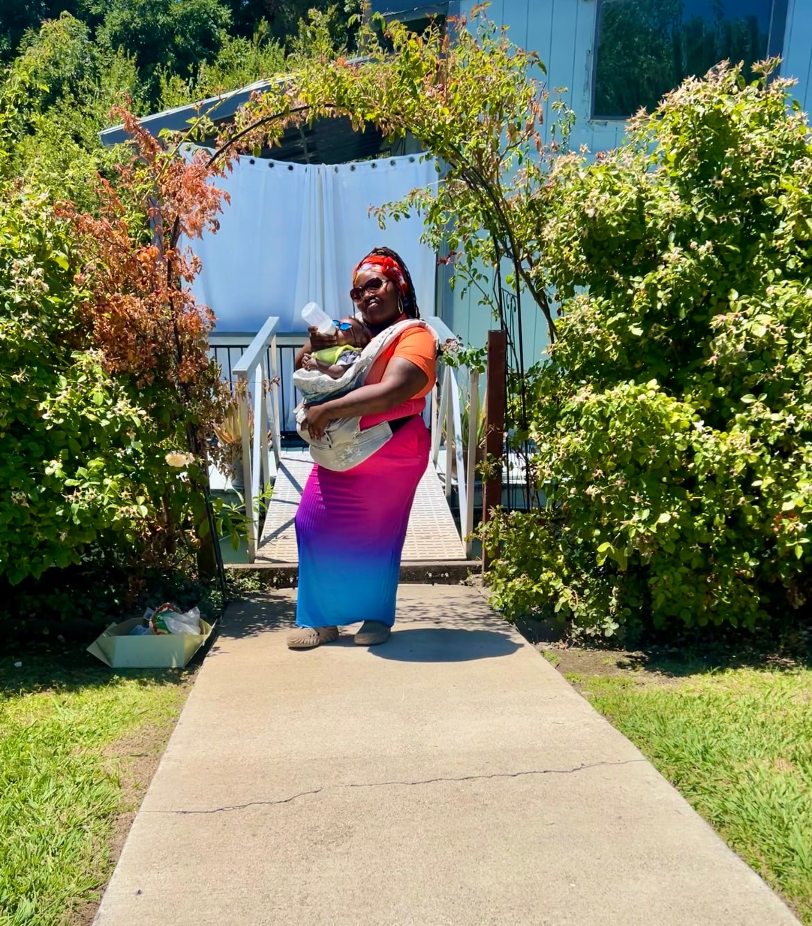 Mother and baby enjoying a sunny garden walk