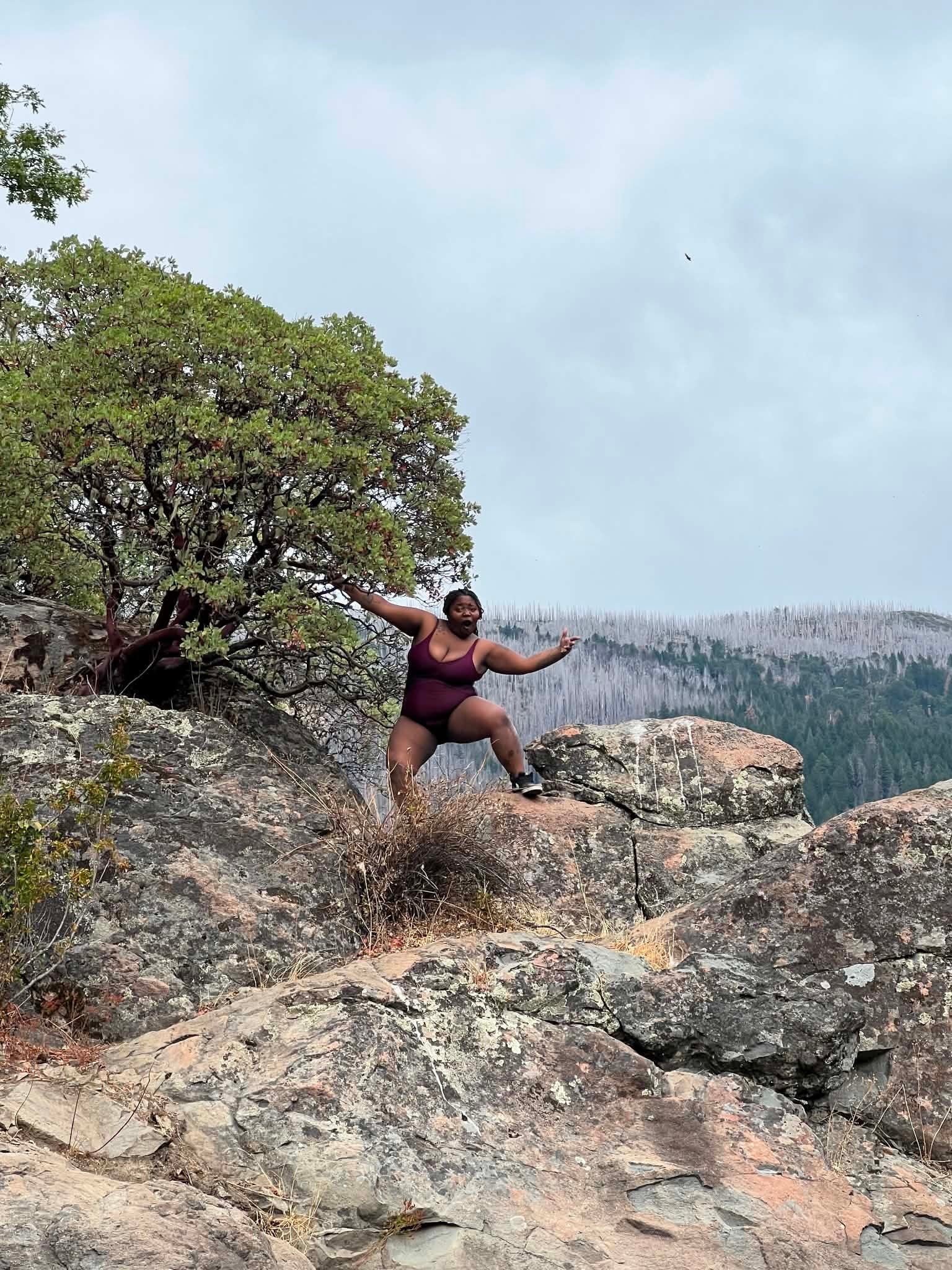 Community member celebrating on a mountain rock adventure