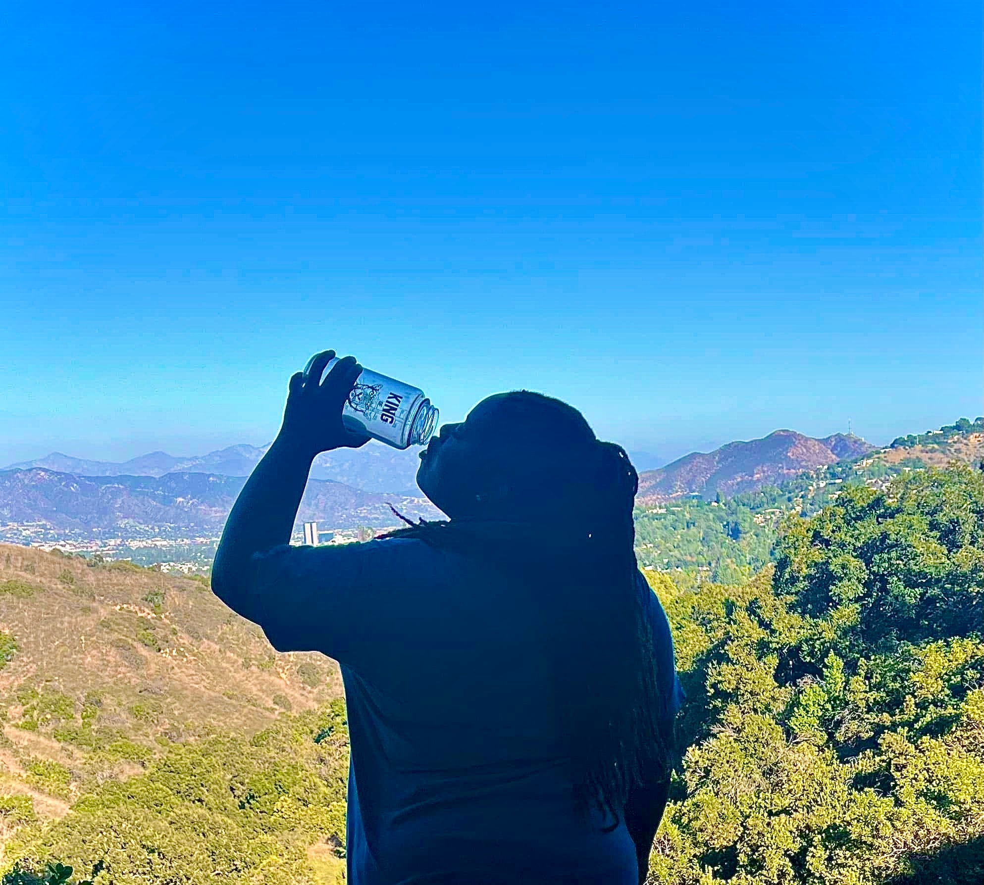Community member taking in a mountain view during a hike