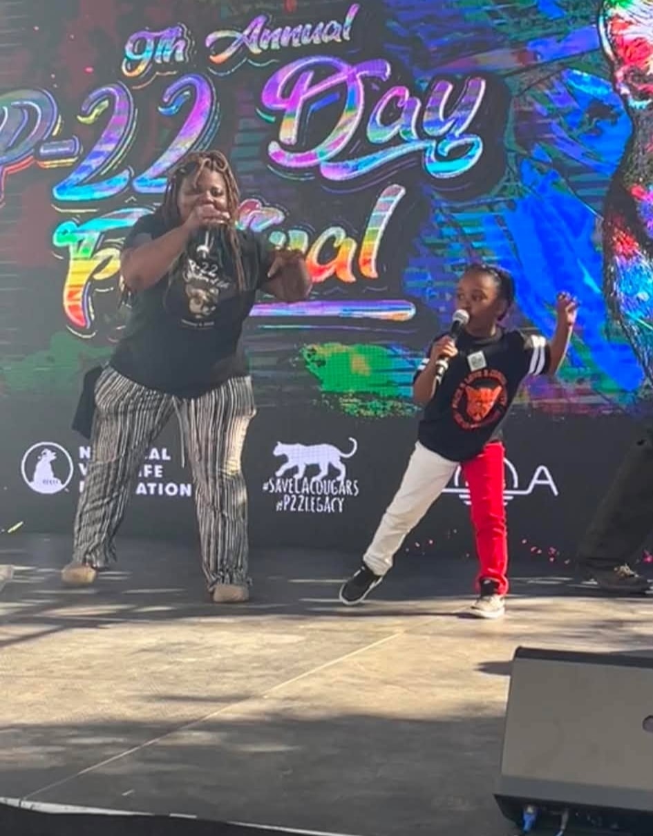 Adult and child performing together on the P-22 Day Festival stage
