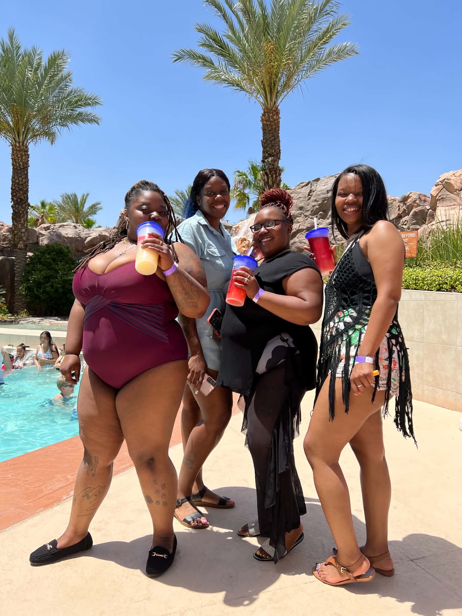 Friends enjoying a sunny resort pool day together