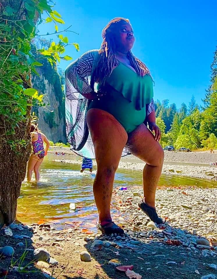 Community member enjoying a river and mountain outing