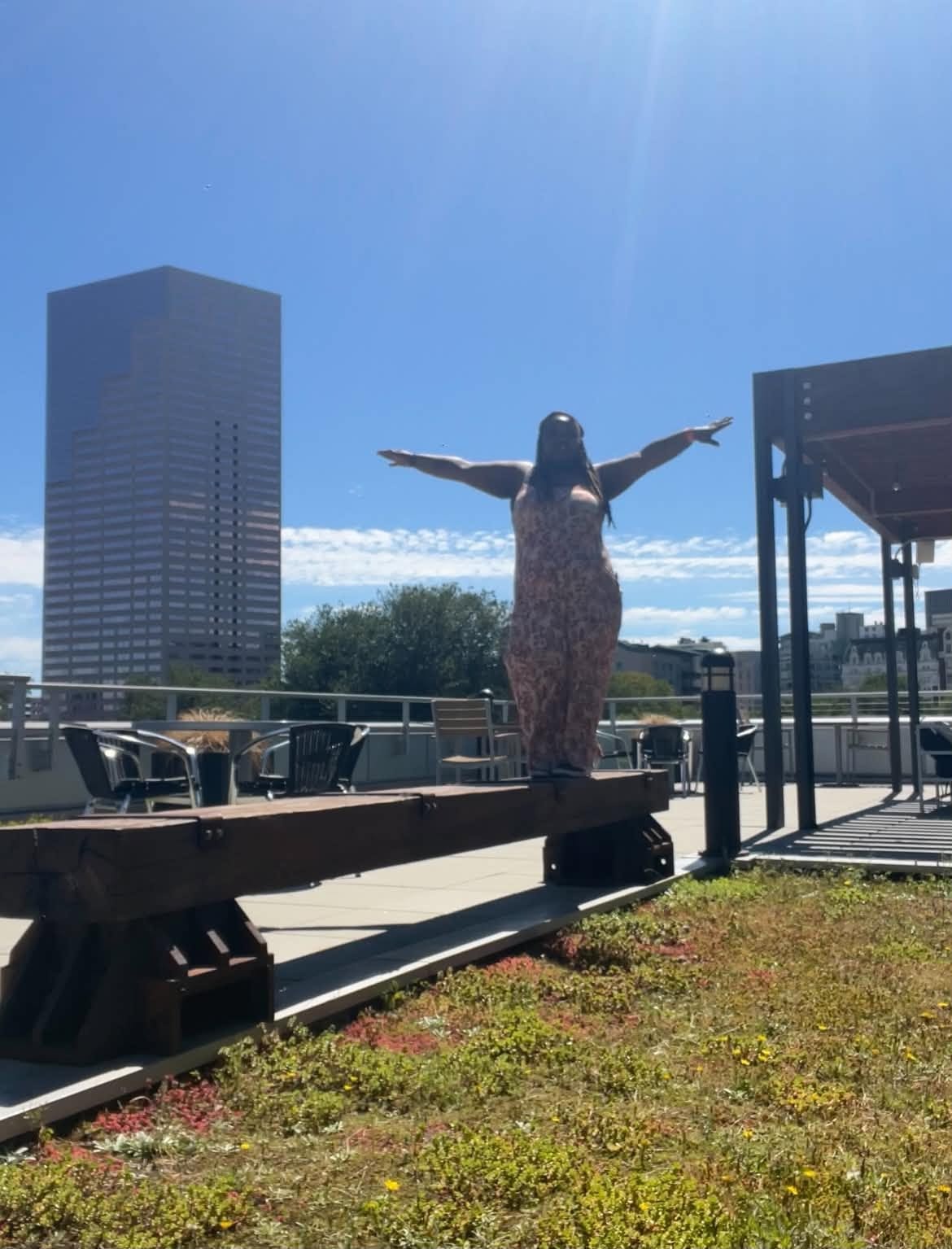 Rooftop terrace sculpture with a city skyline