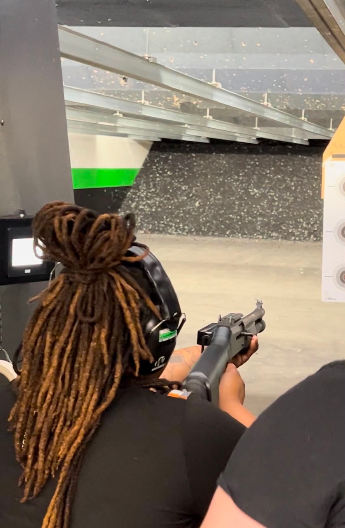 Adult participating in a supervised shooting range safety activity