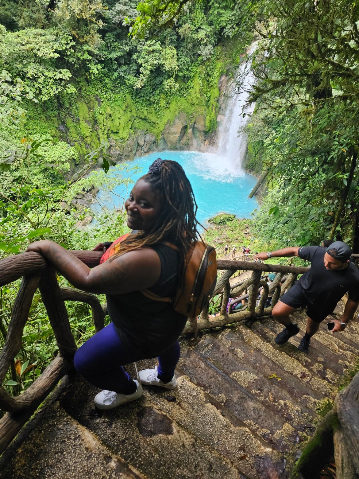 Travel group hiking beside a waterfall in Costa Rica