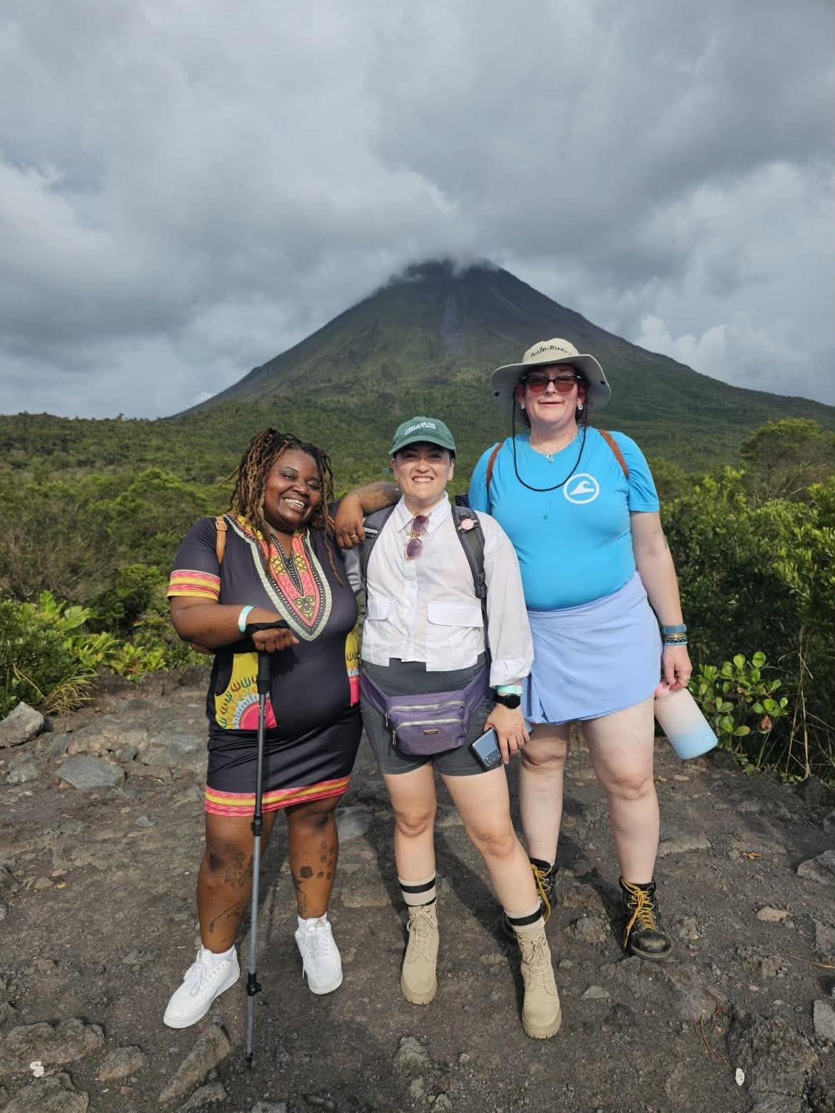 Three hikers sharing a volcano-view adventure