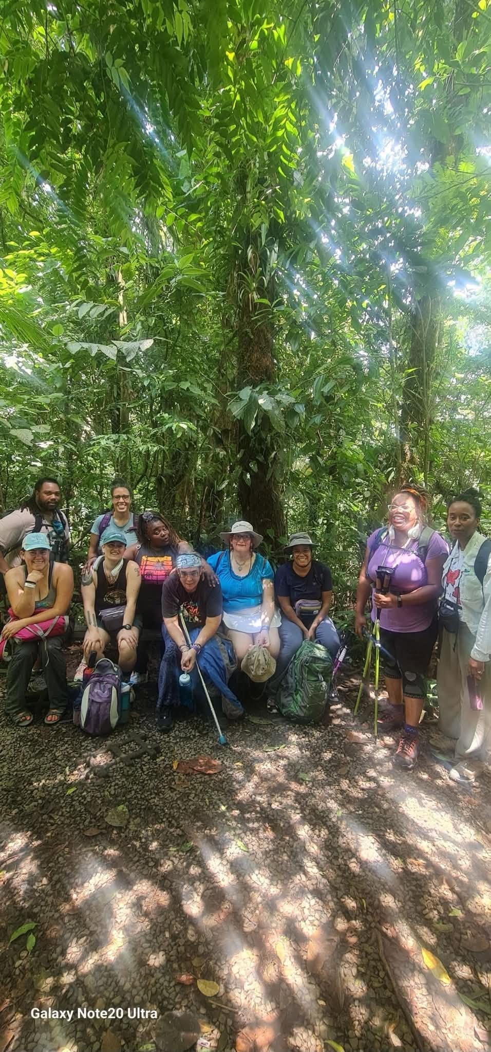 Hiking group gathered in a lush tropical forest